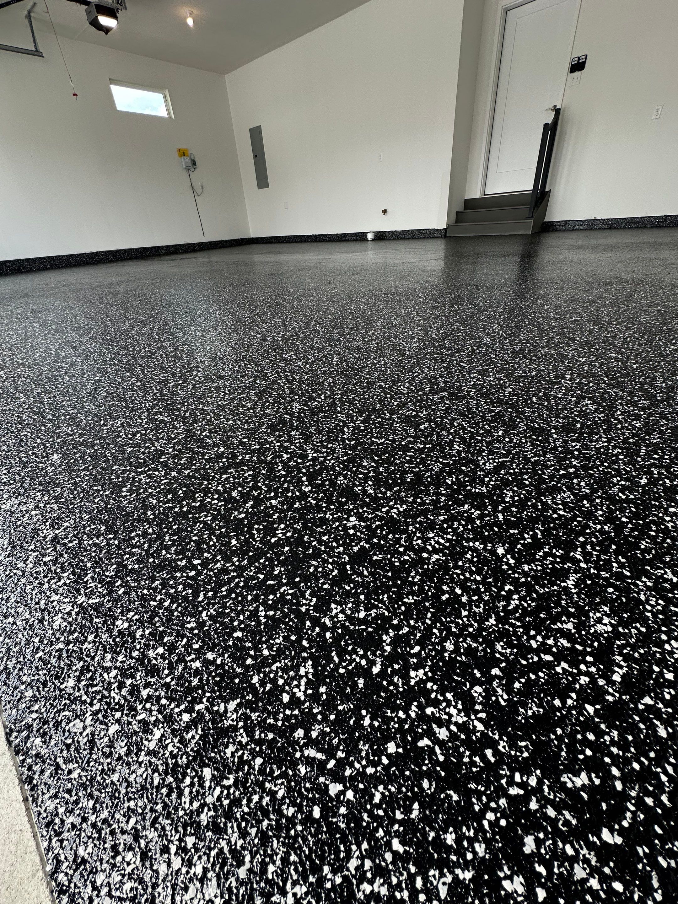 Black and White Speckled Epoxy Garage Floor in Lincoln by Goat Coatings