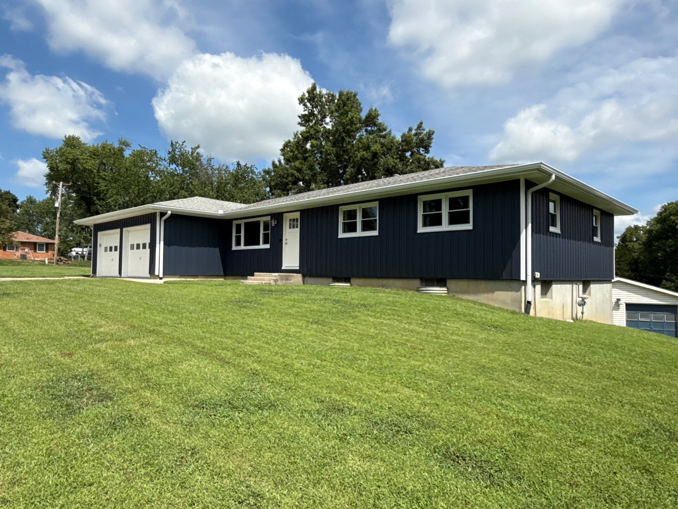 Indigo Board and Batten Siding and Window Replacement in Smithville by EEC Windows, Siding & Roofing