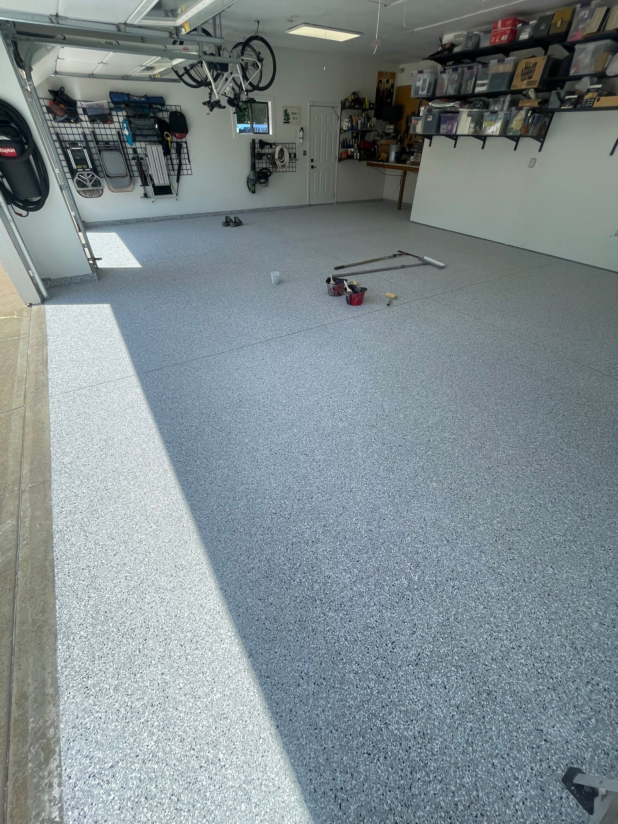 Feather Grey Garage Floor Coating Installation in Sioux Falls by Select Painting, Coatings & Garage Cabinets