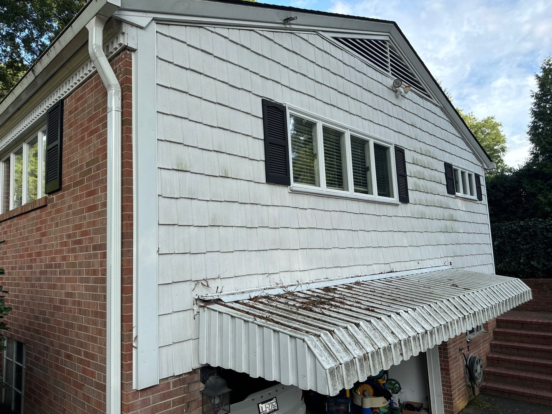 the service shown is cleaning the exterior siding brick and metal roof to remove dirt and debris