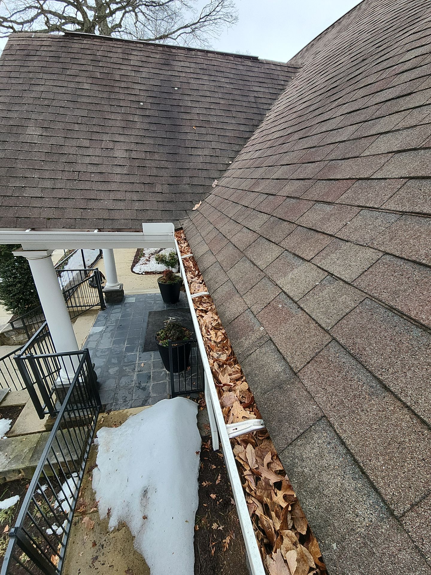 Church gutter cleaning before photo showing entrance gutters.