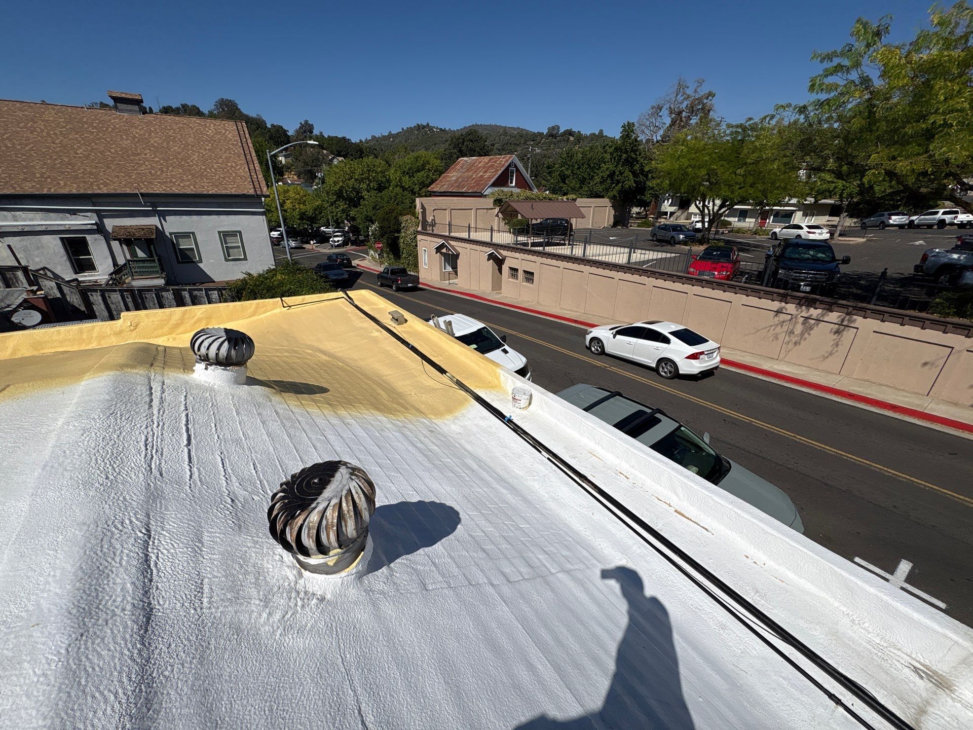 Foam and coatings on commercial roof by Straight Edge Roofing Inc