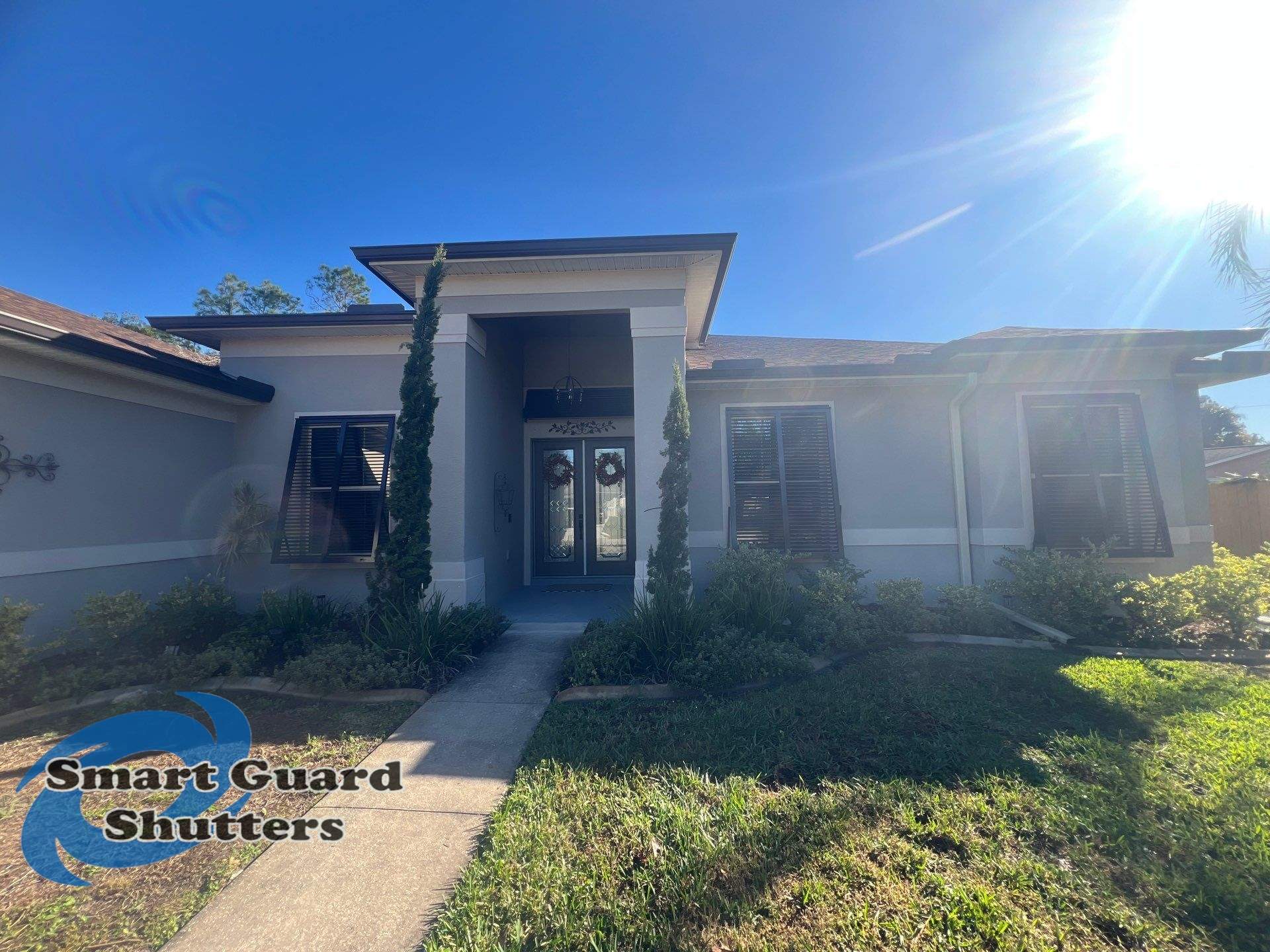 Impact Bahama Shutters in Grey Brown by Smart Guard Shutters