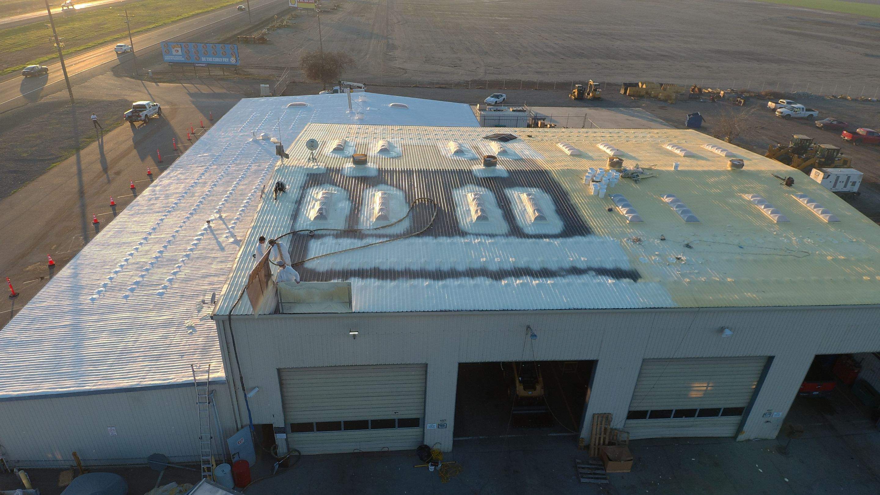 Metal roof restoration on commercial roof using Conklin Benchmark/ PUMA XL acrylic coatings over metal and foam by Straight Edge Roofing Inc