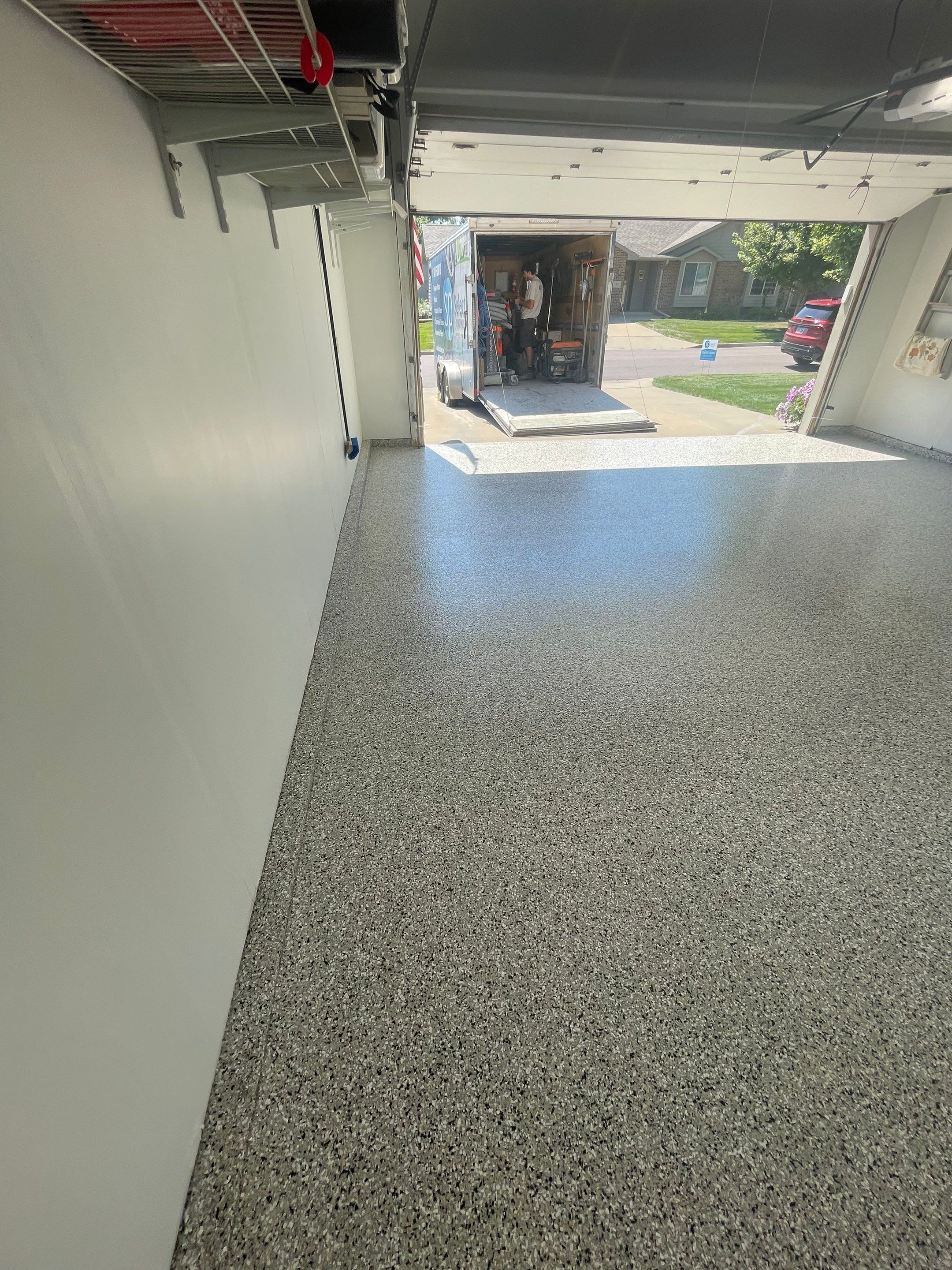 Sioux Falls Residential Garage Floor Coating with Speckled Epoxy Finish by Select Painting, Coatings & Garage Cabinets