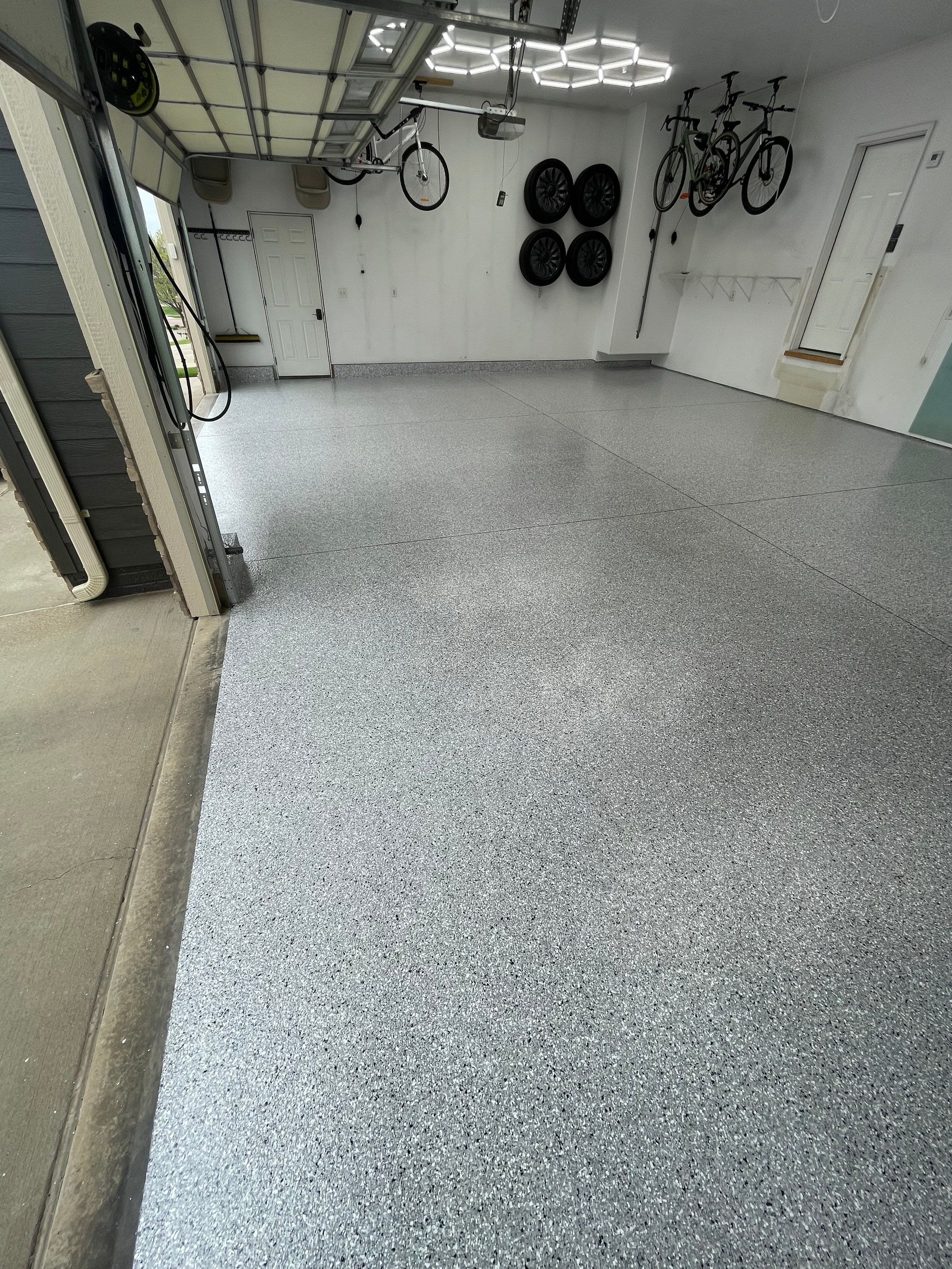 Feather Gray Epoxy Floor Coating Installation in Sioux Falls by Select Painting, Coatings & Garage Cabinets