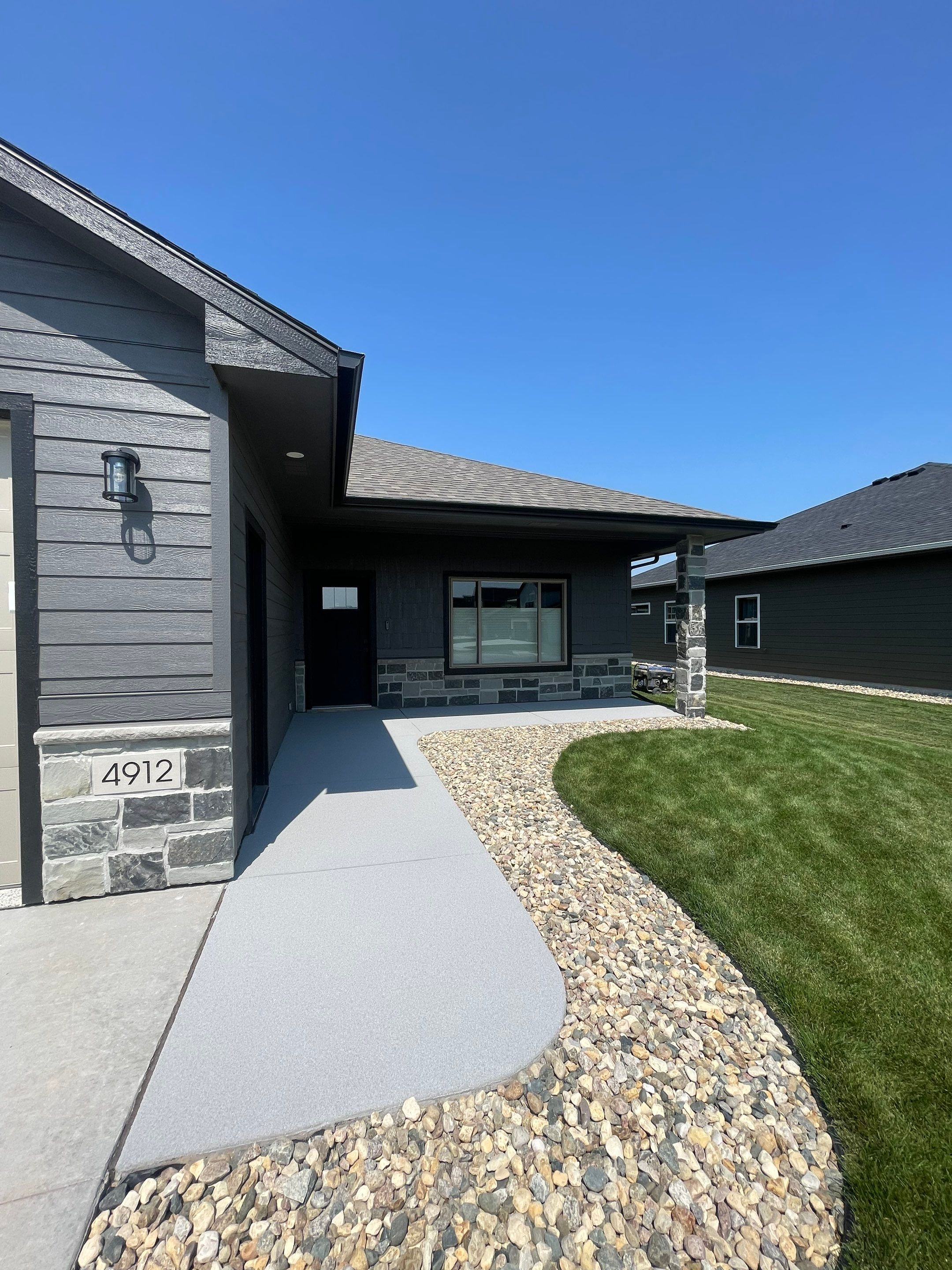 Sioux Falls Residential Concrete Patio and Walkway Coating by Select Painting, Coatings & Garage Cabinets