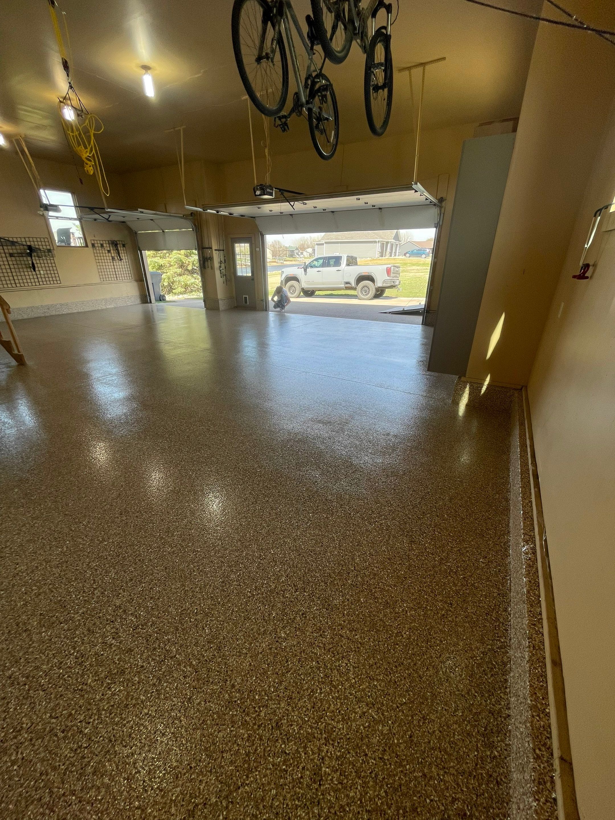 Residential Garage Floor Transformation with Speckled Epoxy Coating by Select Painting, Coatings & Garage Cabinets