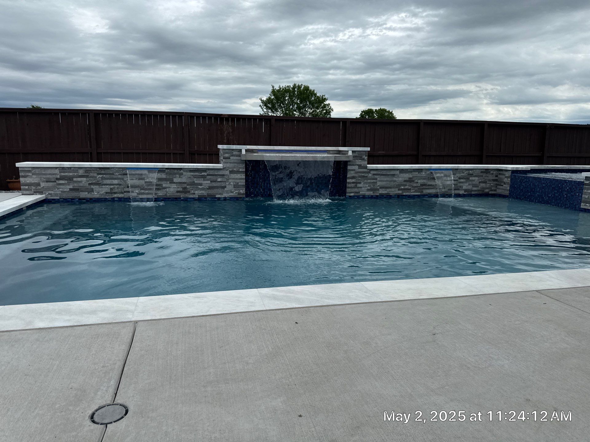 Geometric Pool and Spa with Stone Water Feature Wall by Pinnacle Pools and Spas - DFW