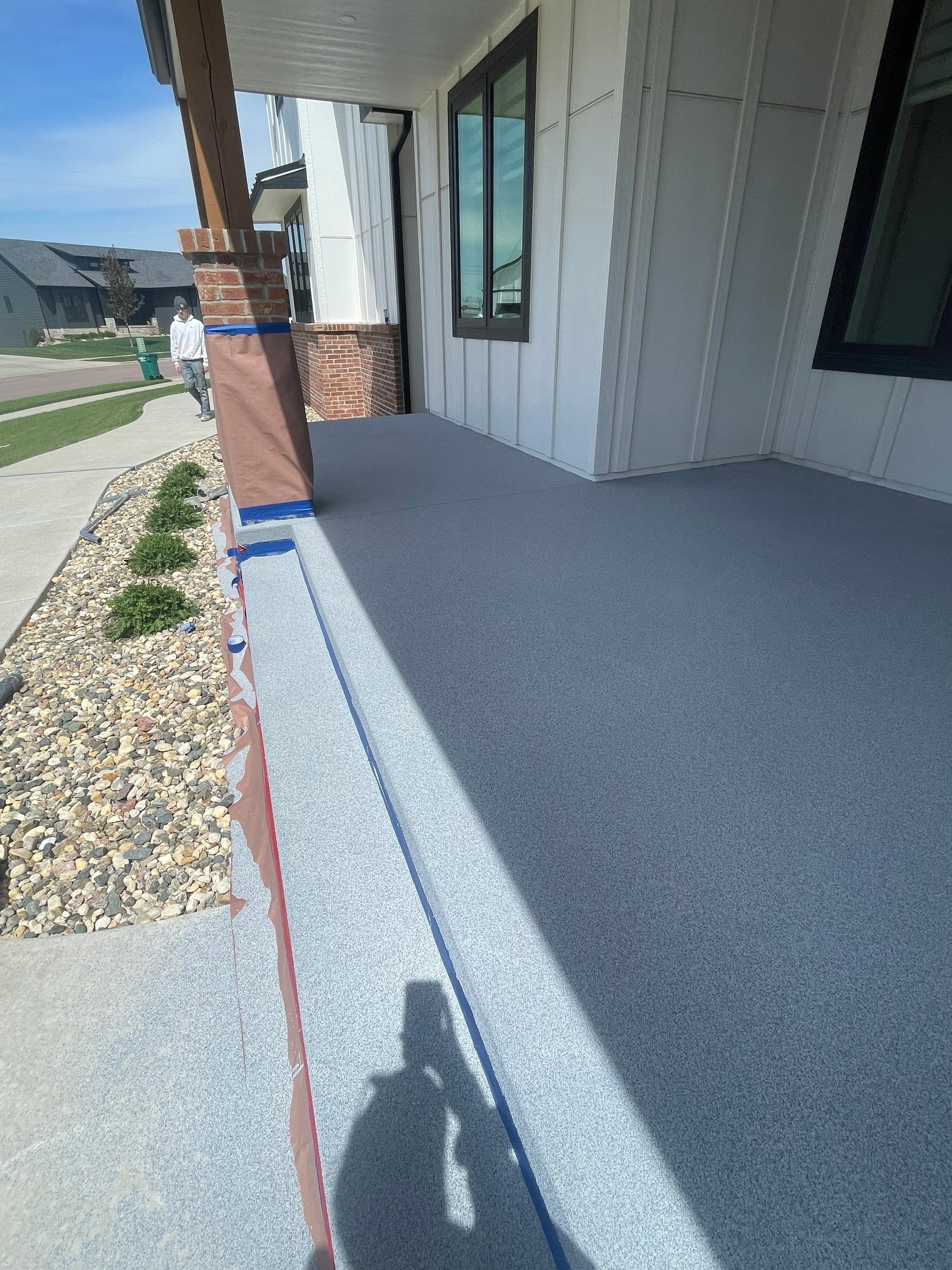 Grey Speckled Concrete Porch Coating for Sioux Falls Home by Select Painting, Coatings & Garage Cabinets