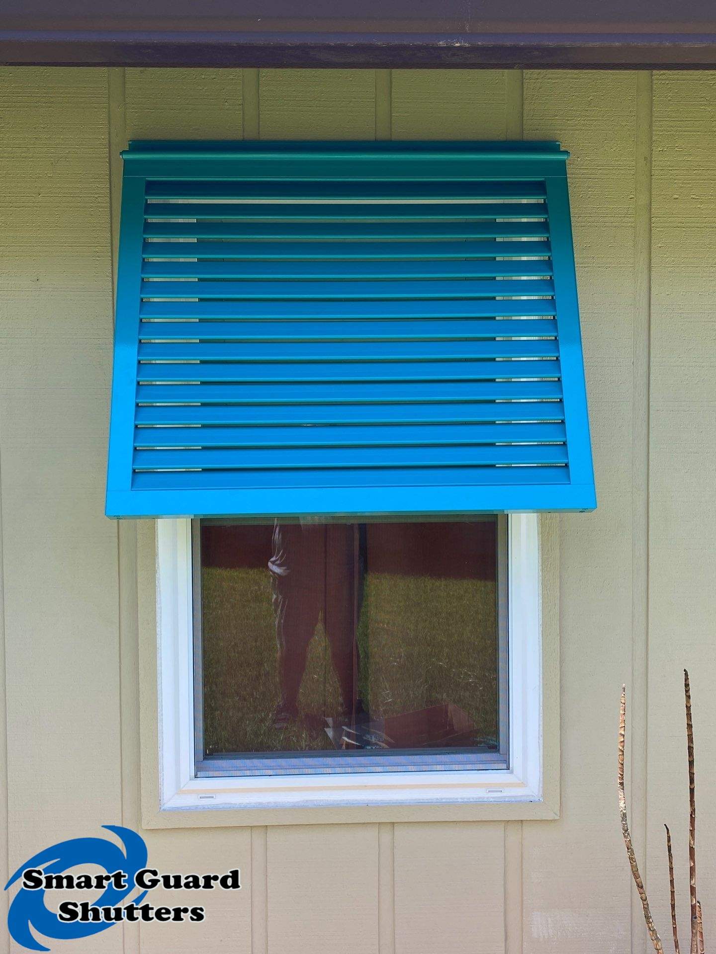 Decorative Bahama Shutters in Turquoise Blue  by Smart Guard Shutters