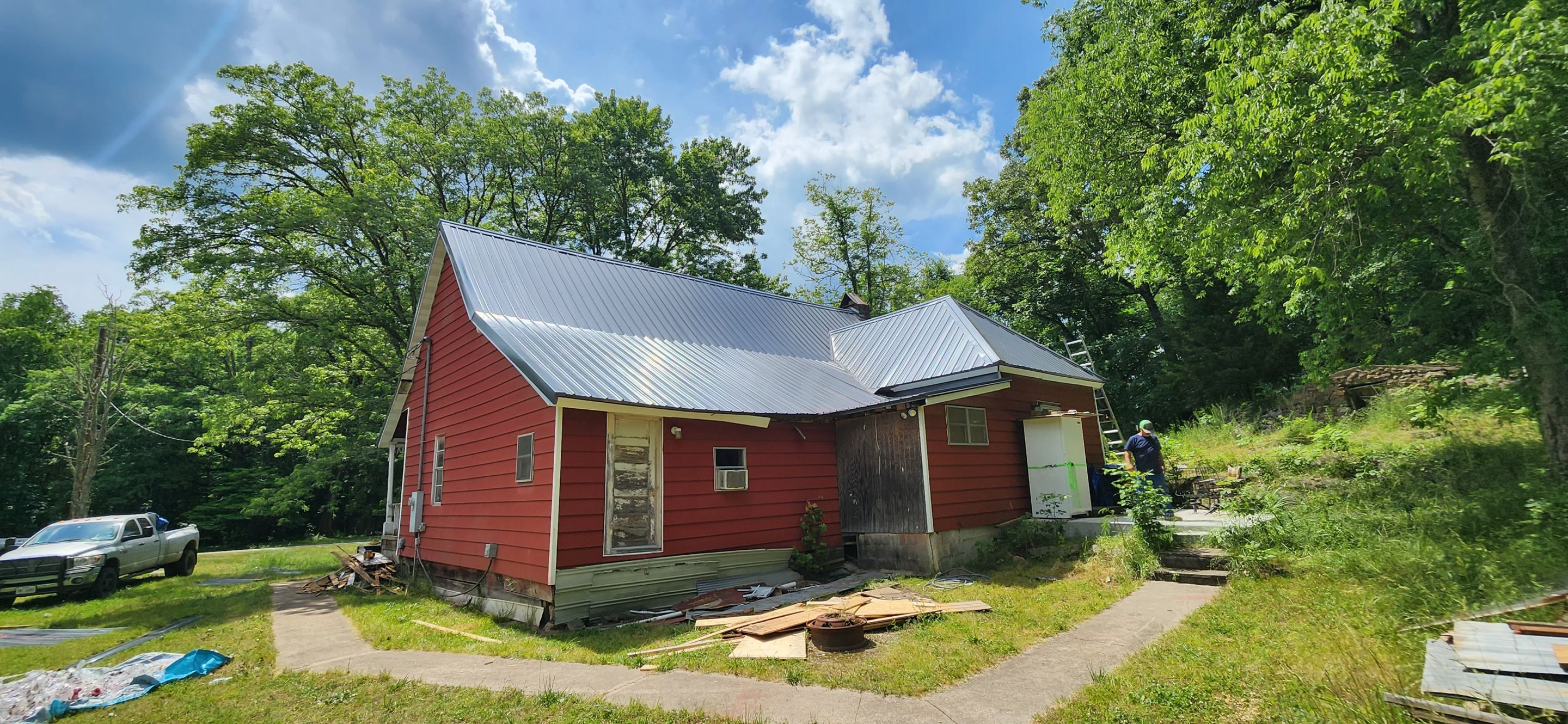 Residential Roofing Installation using 26 Gauge Colored Panels by Hostetler Roofing