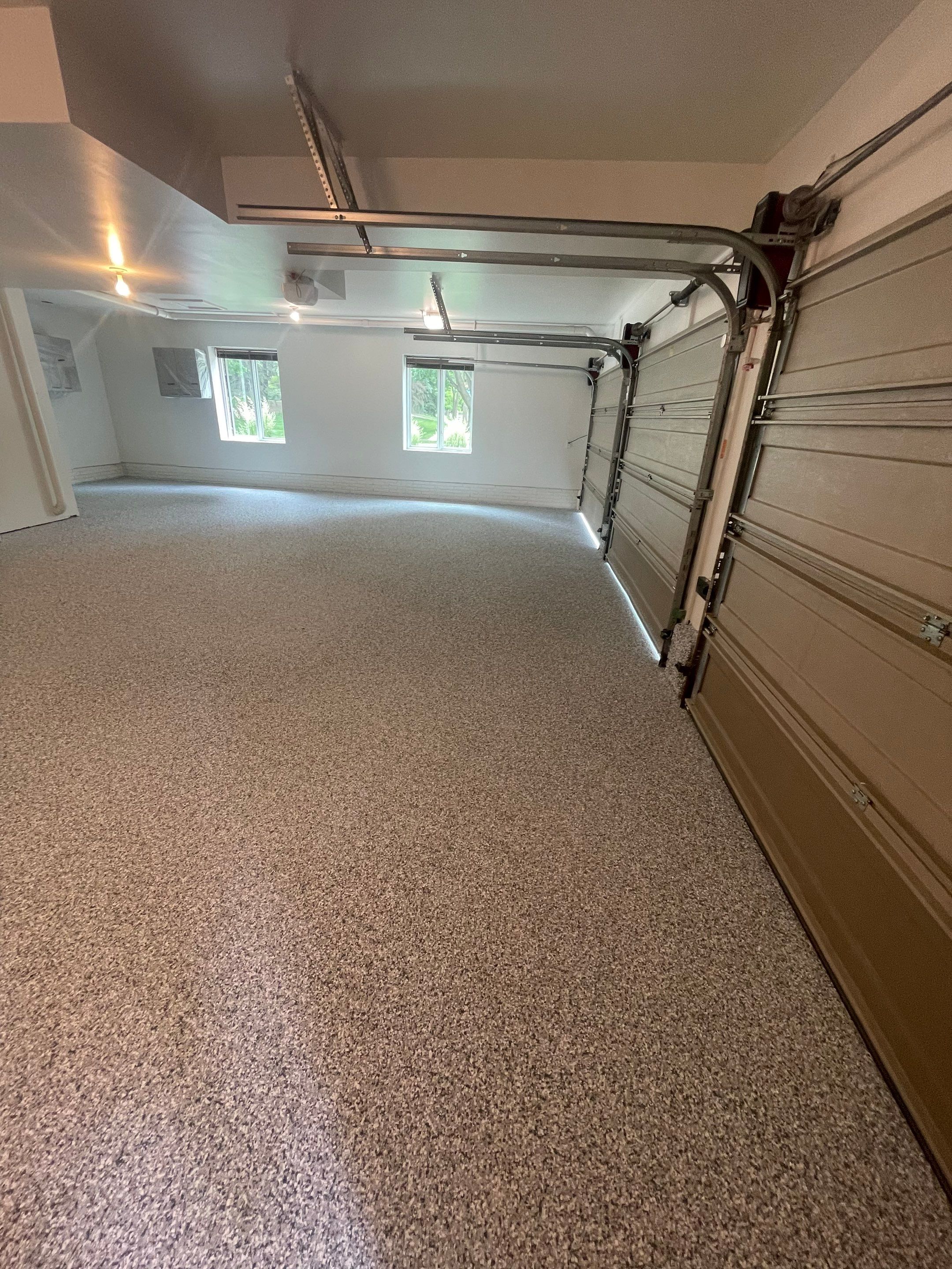 Gray Speckled Epoxy Garage Floor Coating in Sioux Falls by Select Painting, Coatings & Garage Cabinets