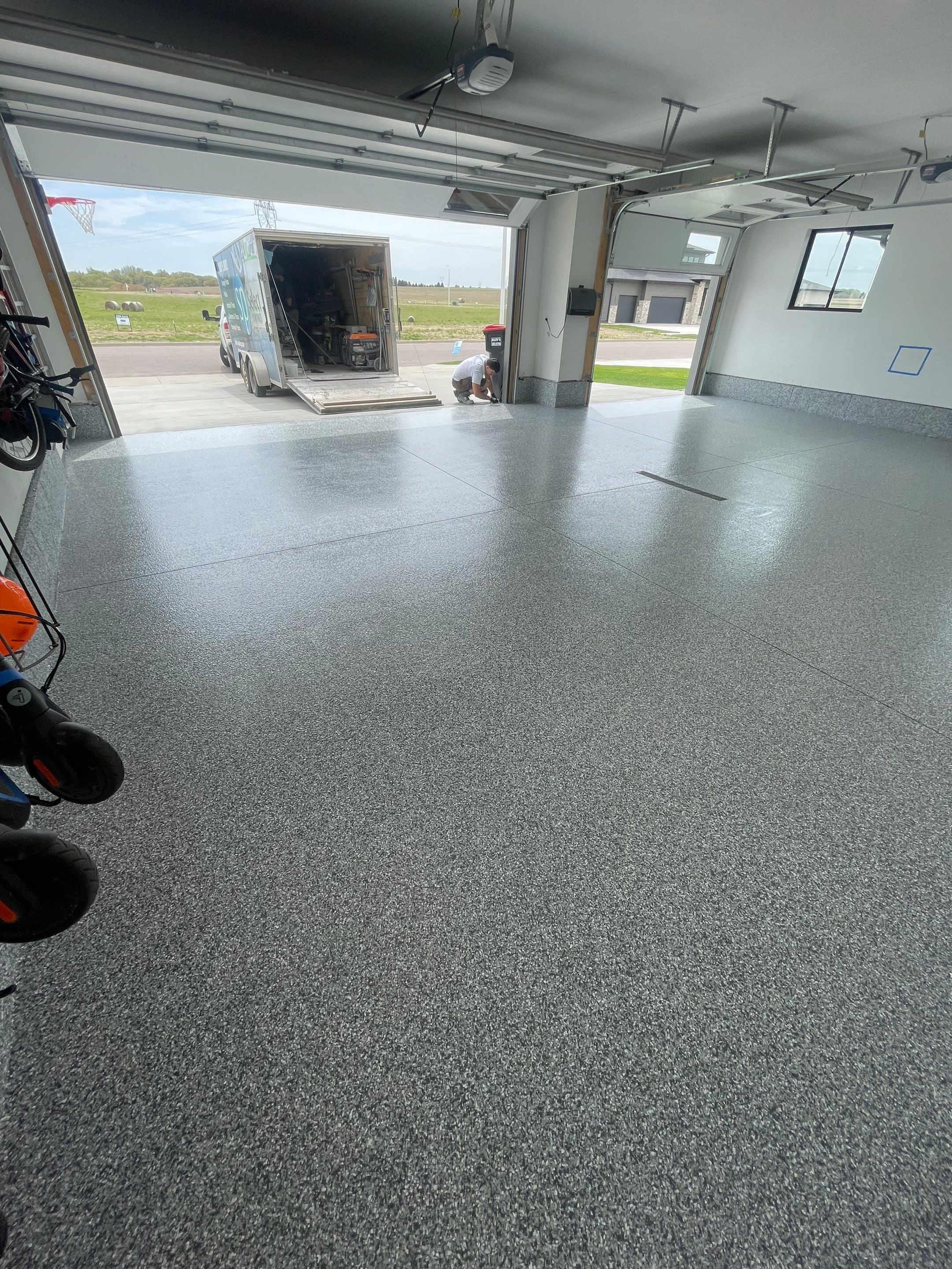 Full Garage Concrete Coating with Grey Speckled Epoxy in Brandon by Select Painting, Coatings & Garage Cabinets