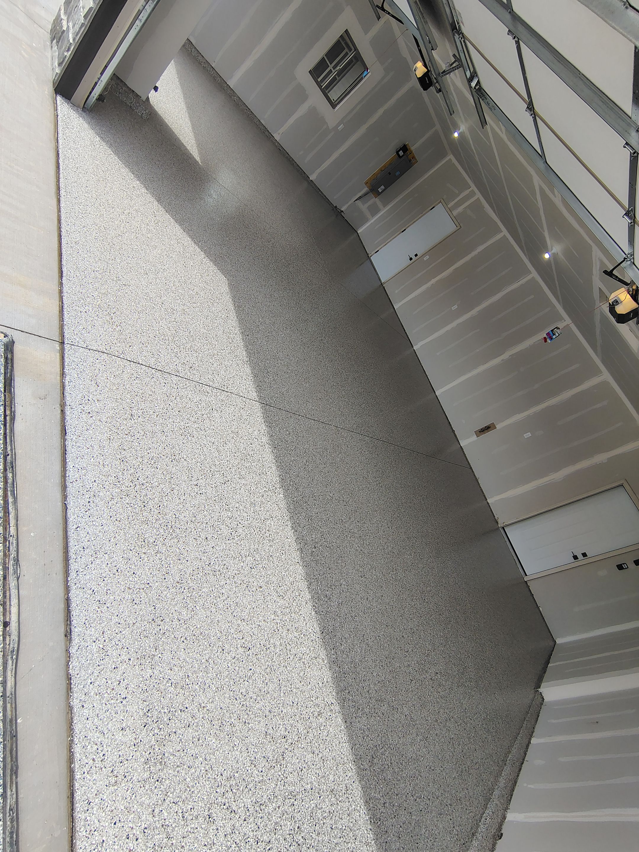 Speckled Epoxy Garage Floor Coating Installation in Sioux Falls by Select Painting, Coatings & Garage Cabinets