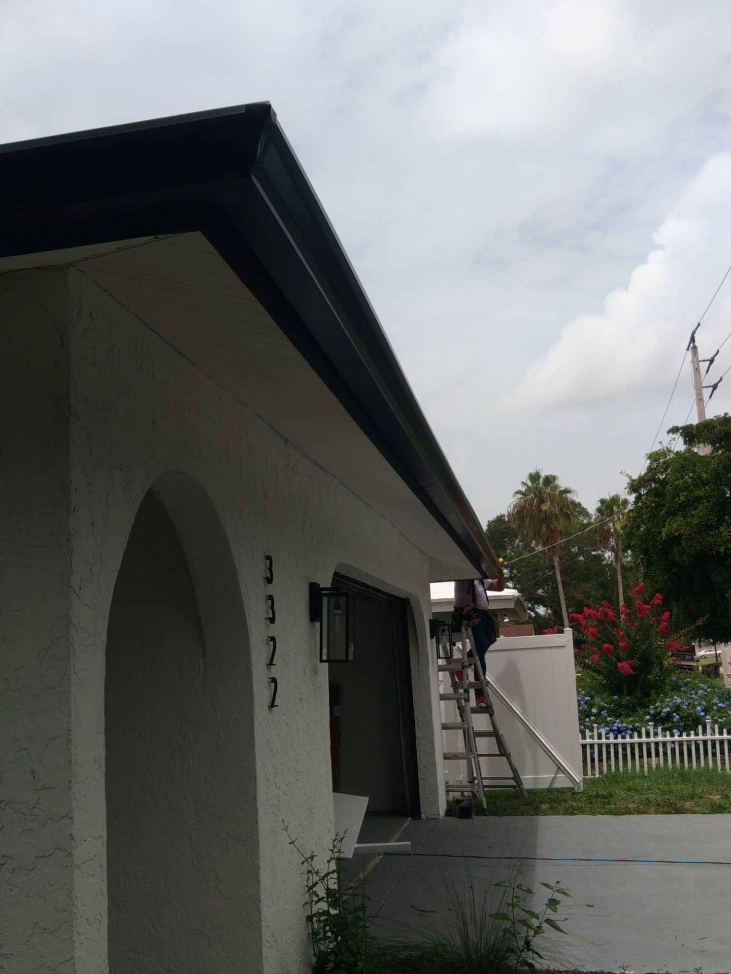 Black seamless gutters and downspouts installation in Sarasota, FL by Gutter Professors