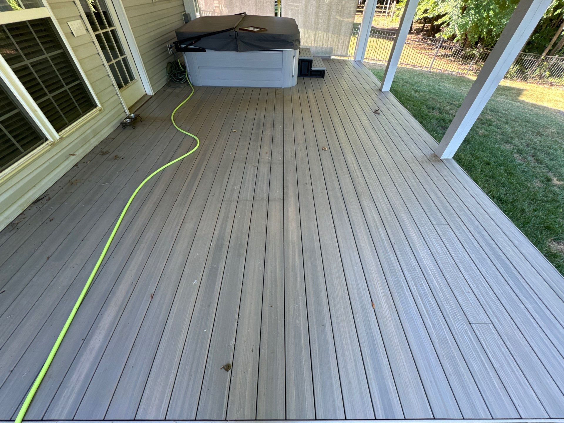 cleaning dirt and debris from a residential deck and exterior walls of a home