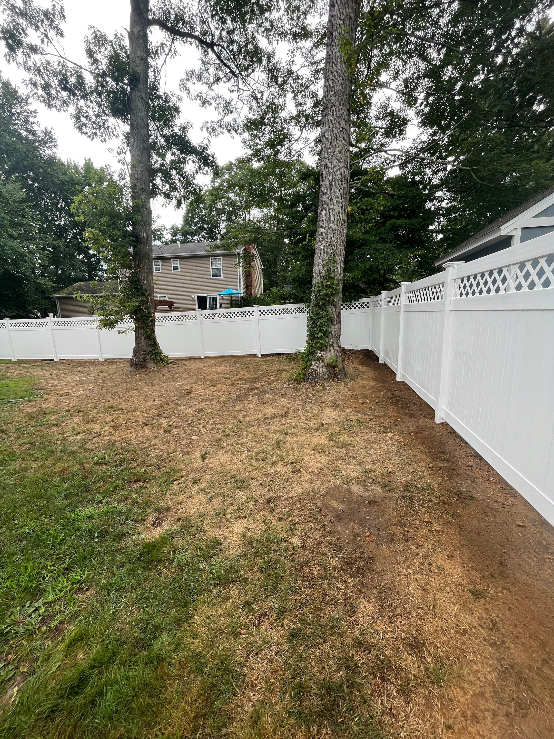 Vinyl privacy fence with Lattice top, White  by DiGiorgi Roofing and Siding Inc