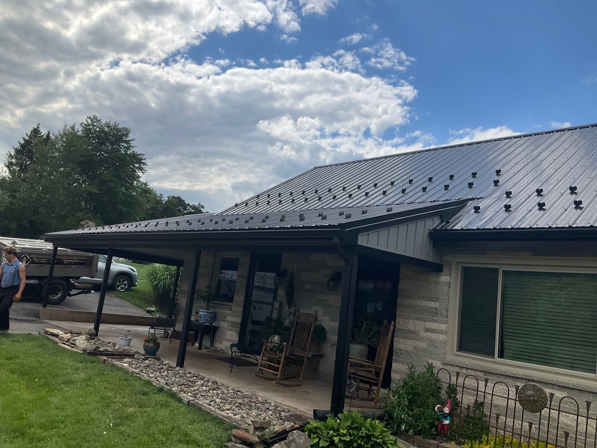Metal Roofing, Board & Batten Siding, and Entry Door Transformation by Esh Builders