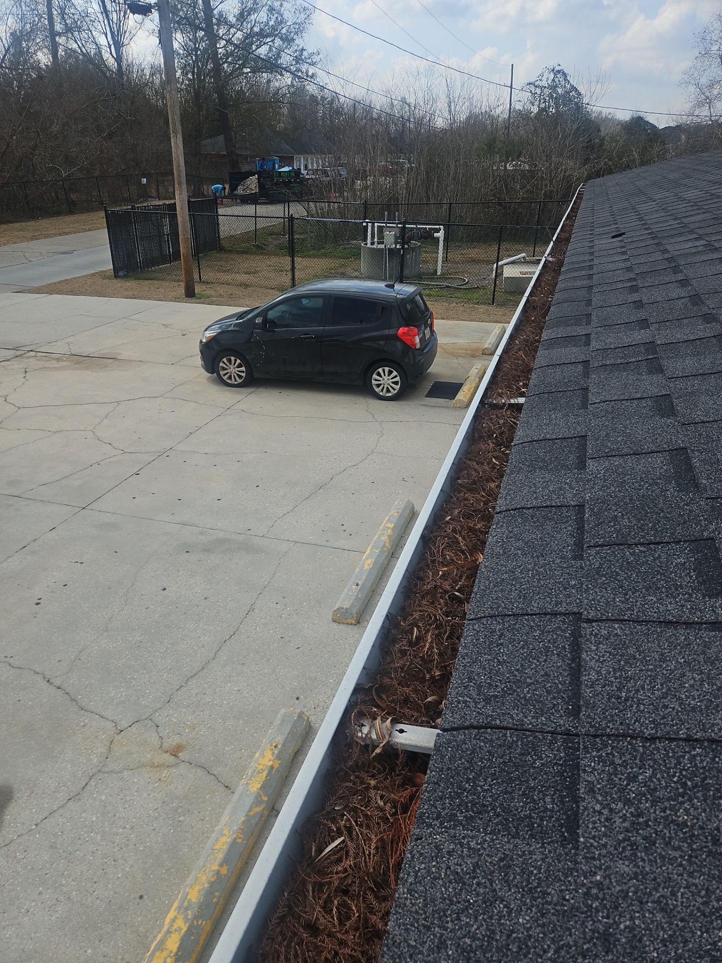 Commercial gutter cleaning New Orleans before photo with filled gutters