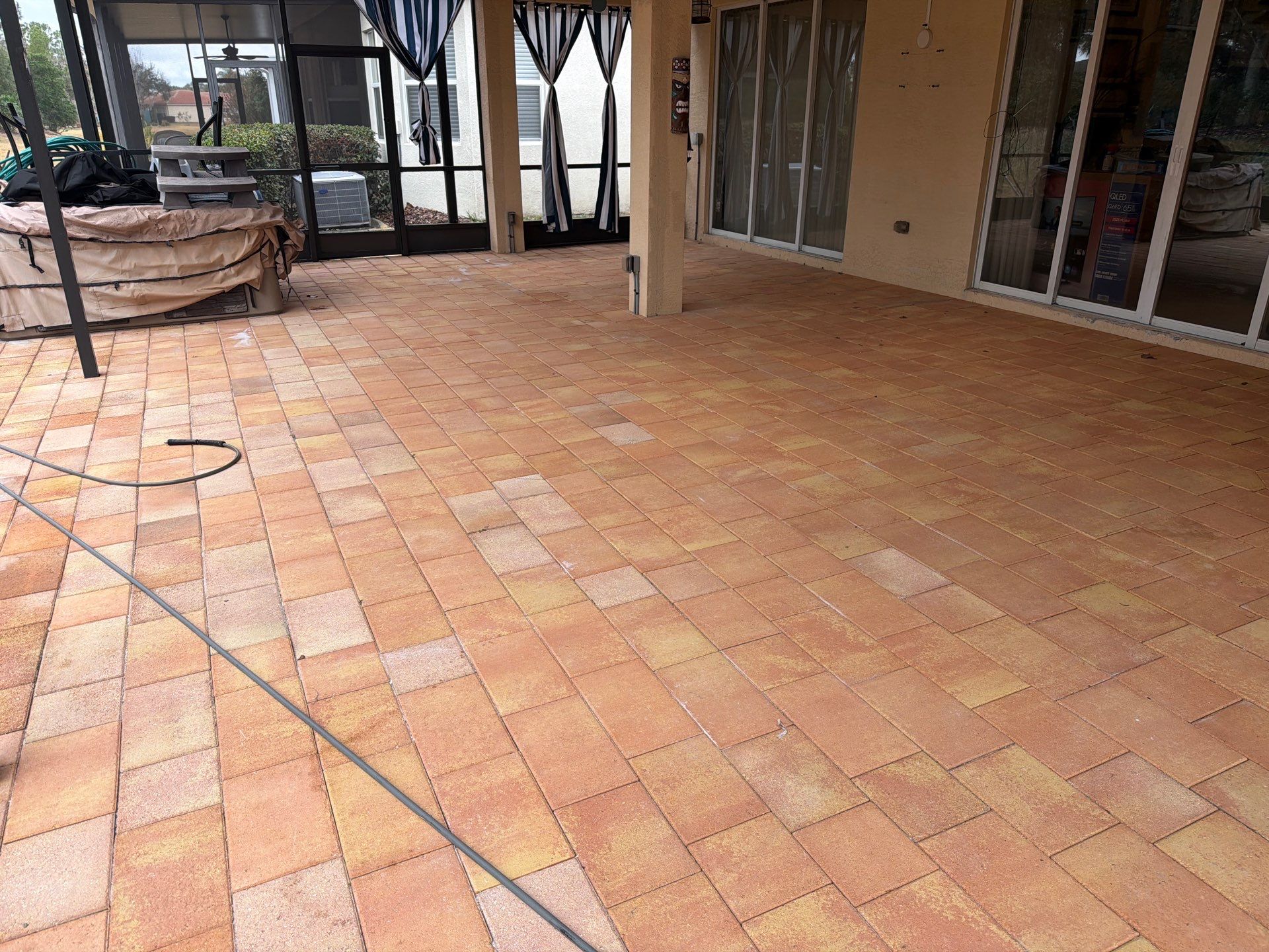 Paver Sealing for Herringbone Driveway and Screened Lanai in Valencia Lakes by Supreme Paver Experts