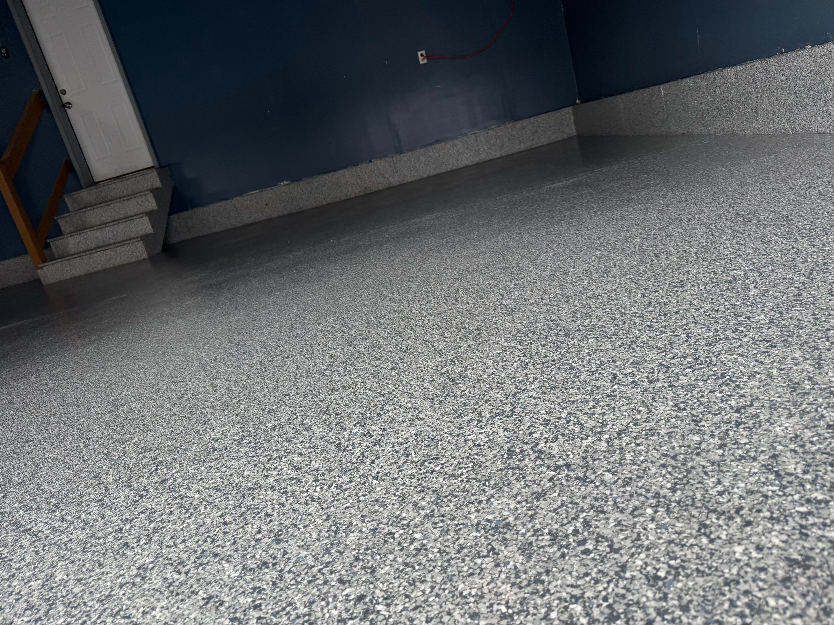 Grey Speckled Epoxy Garage Floor and Stair Coating in Sioux Falls by Select Painting, Coatings & Garage Cabinets