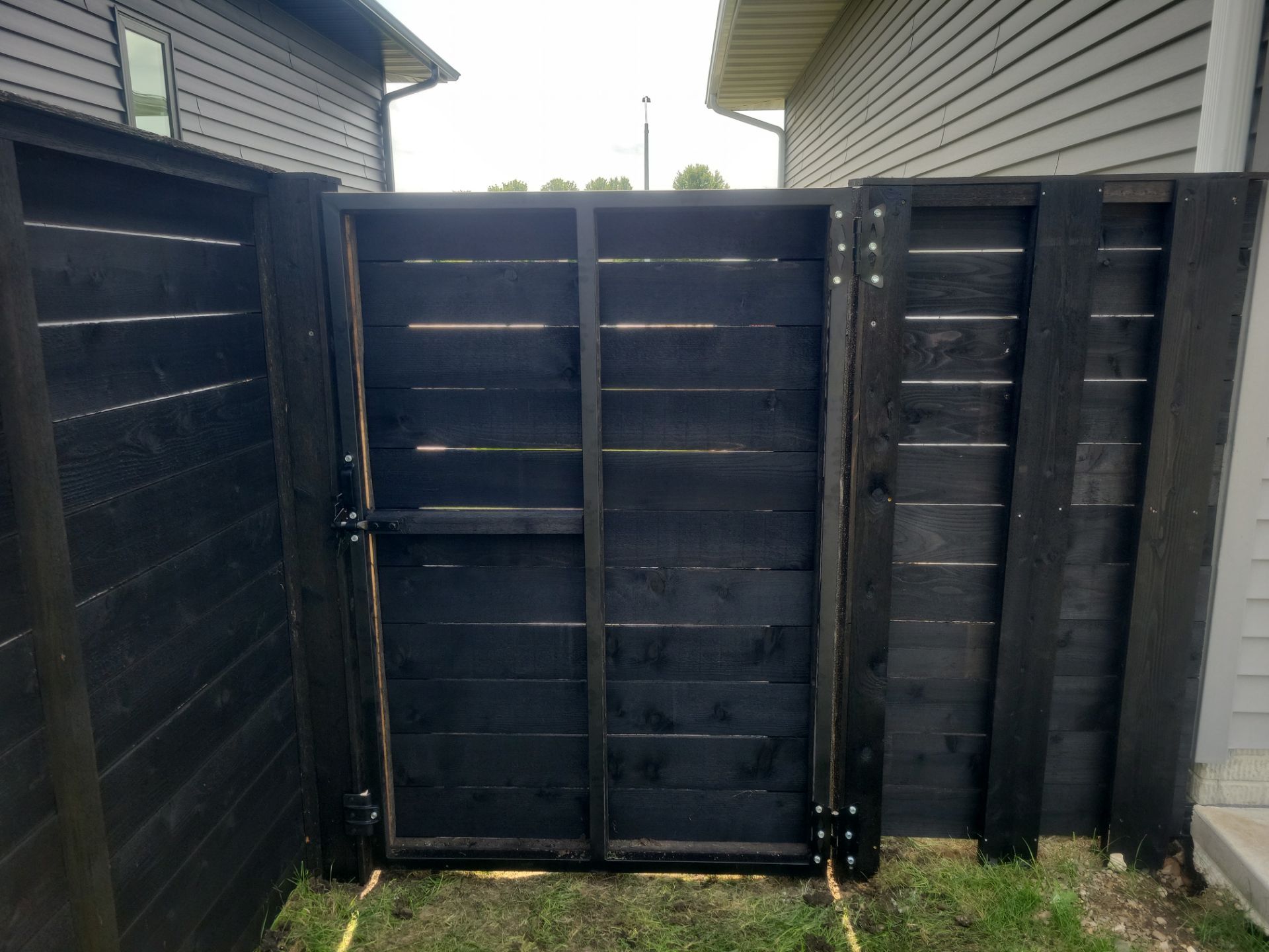 Modern Black Stained Horizontal Privacy Fence Installation in Cedar by Perfect Picket Fence and Stain