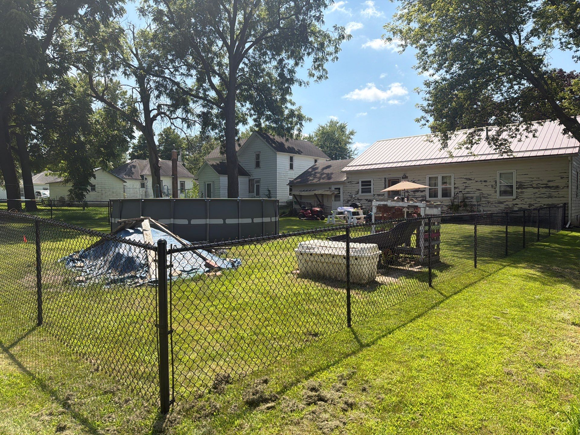 Black Chain Link Backyard Fence Installation in Tripoli, IA by Perfect Picket Fence and Stain