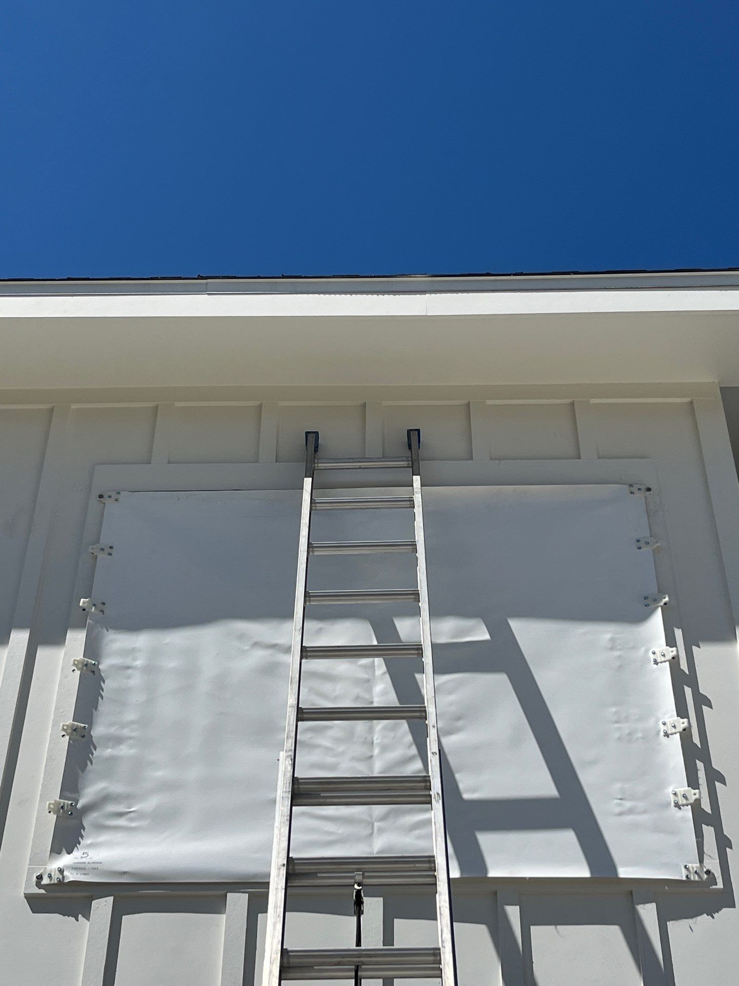 Custom Hurricane Fabric Storm Shutter Installation in Panama City by Brannan Aluminum Inc.