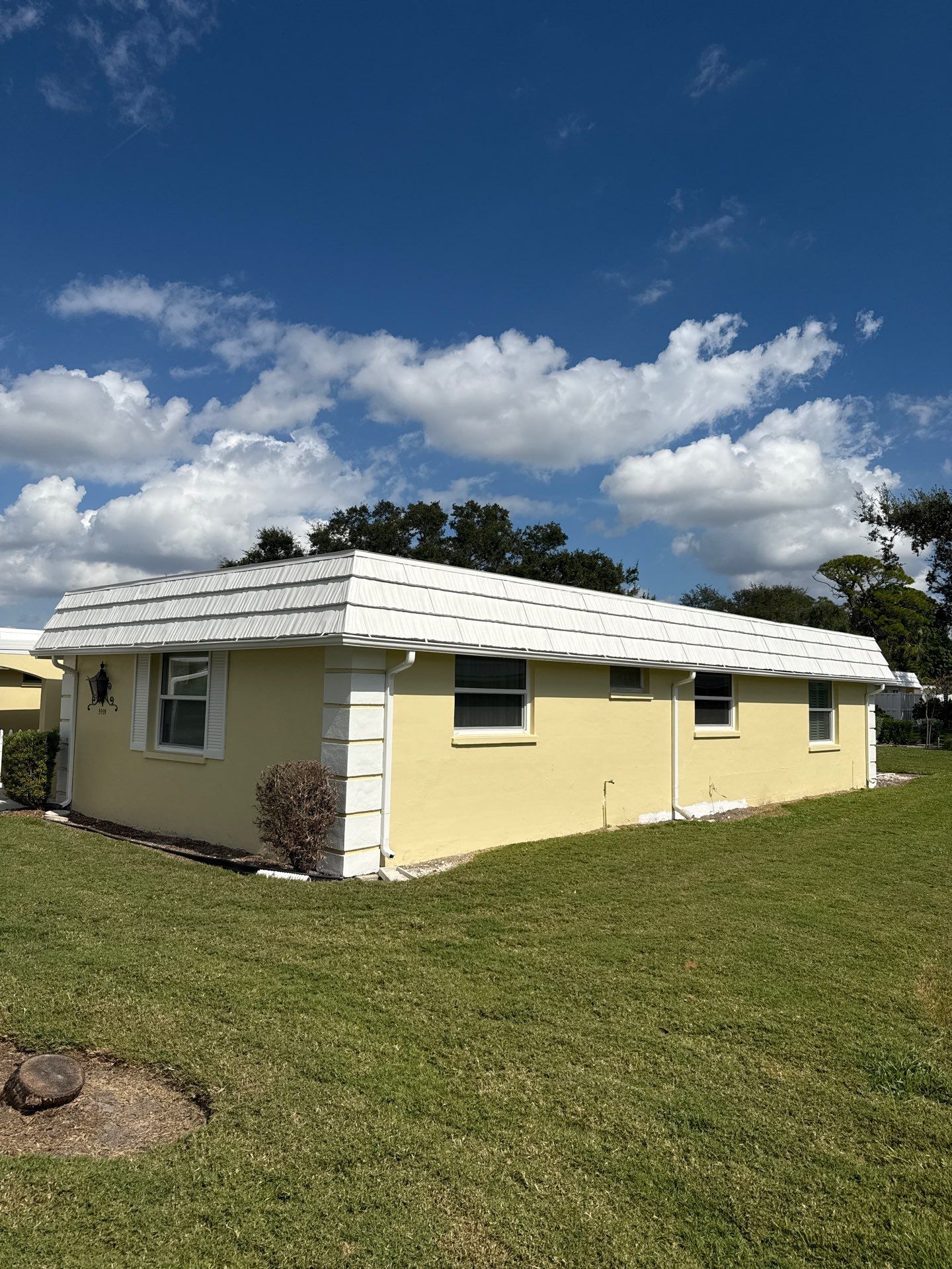 White Gutters and Matching Downspouts in Sarasota FL by Gutter Professors