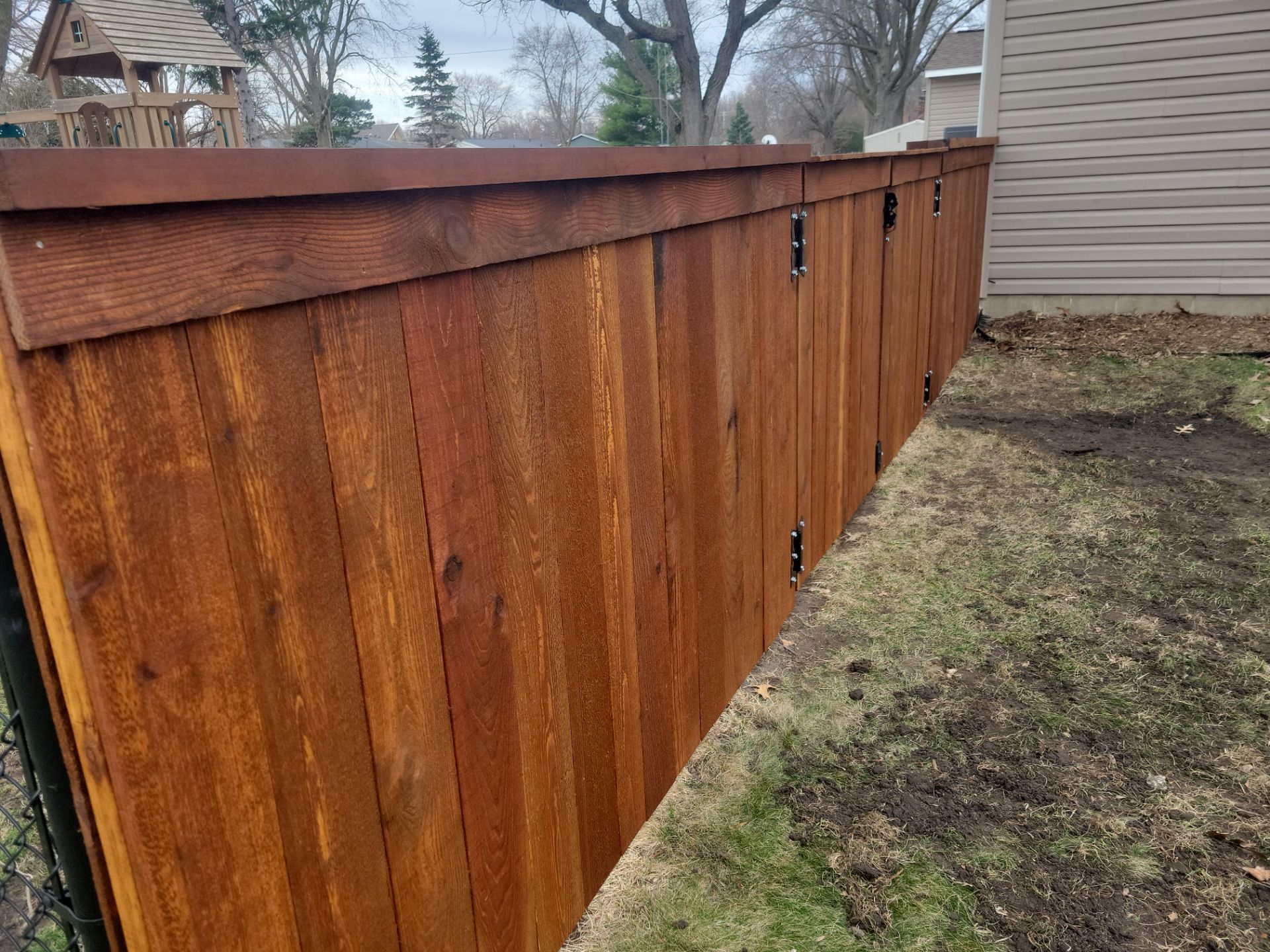 Dark Stained Cedar Privacy Fence and Custom Gates in Cedar Falls by Perfect Picket Fence and Stain