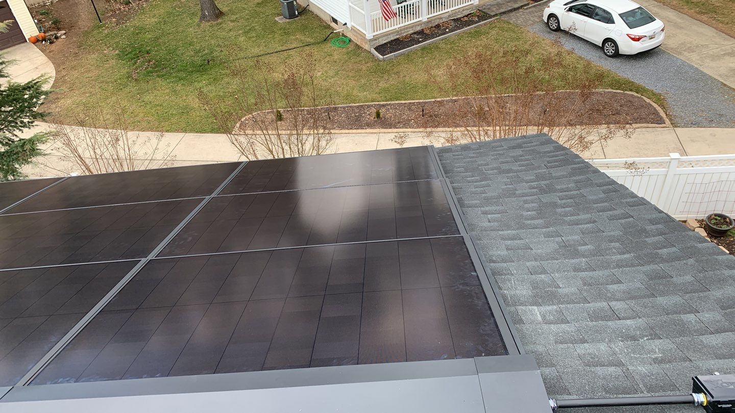 Roof Replacement with GAF Decotech integrated solar panels by American Home Contractors