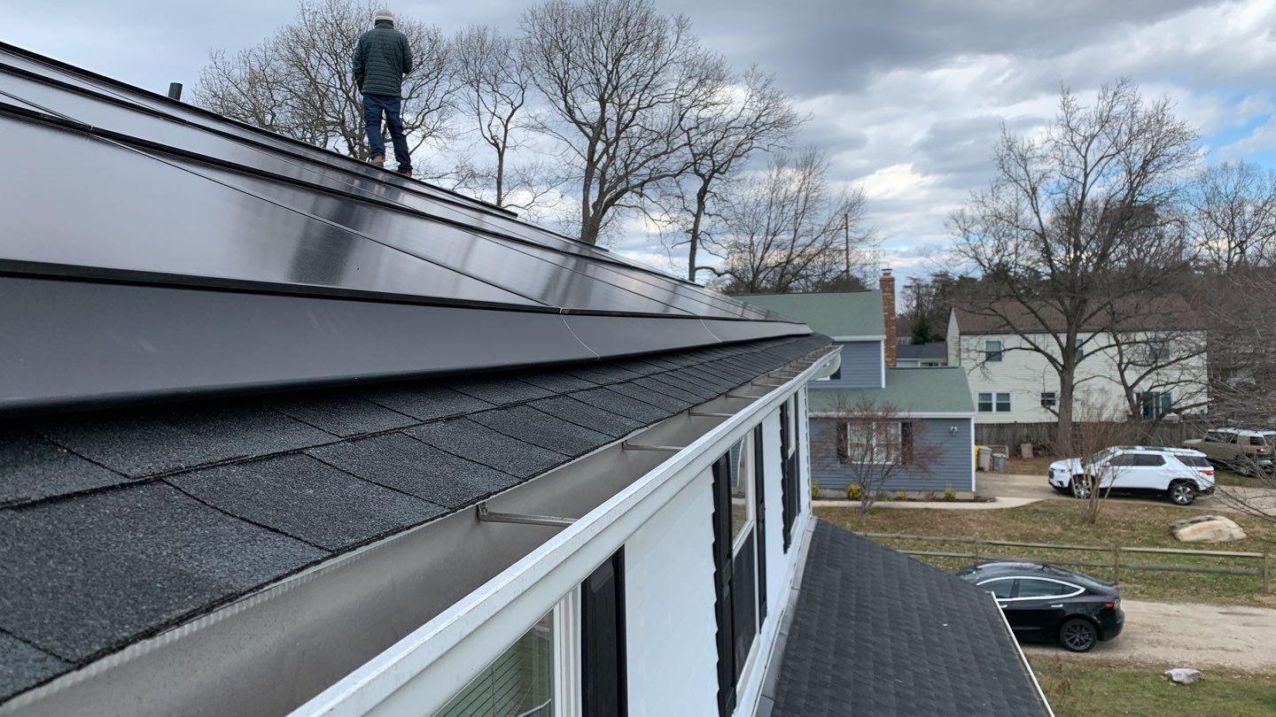 Roof Replacement with GAF Decotech integrated solar panels by American Home Contractors