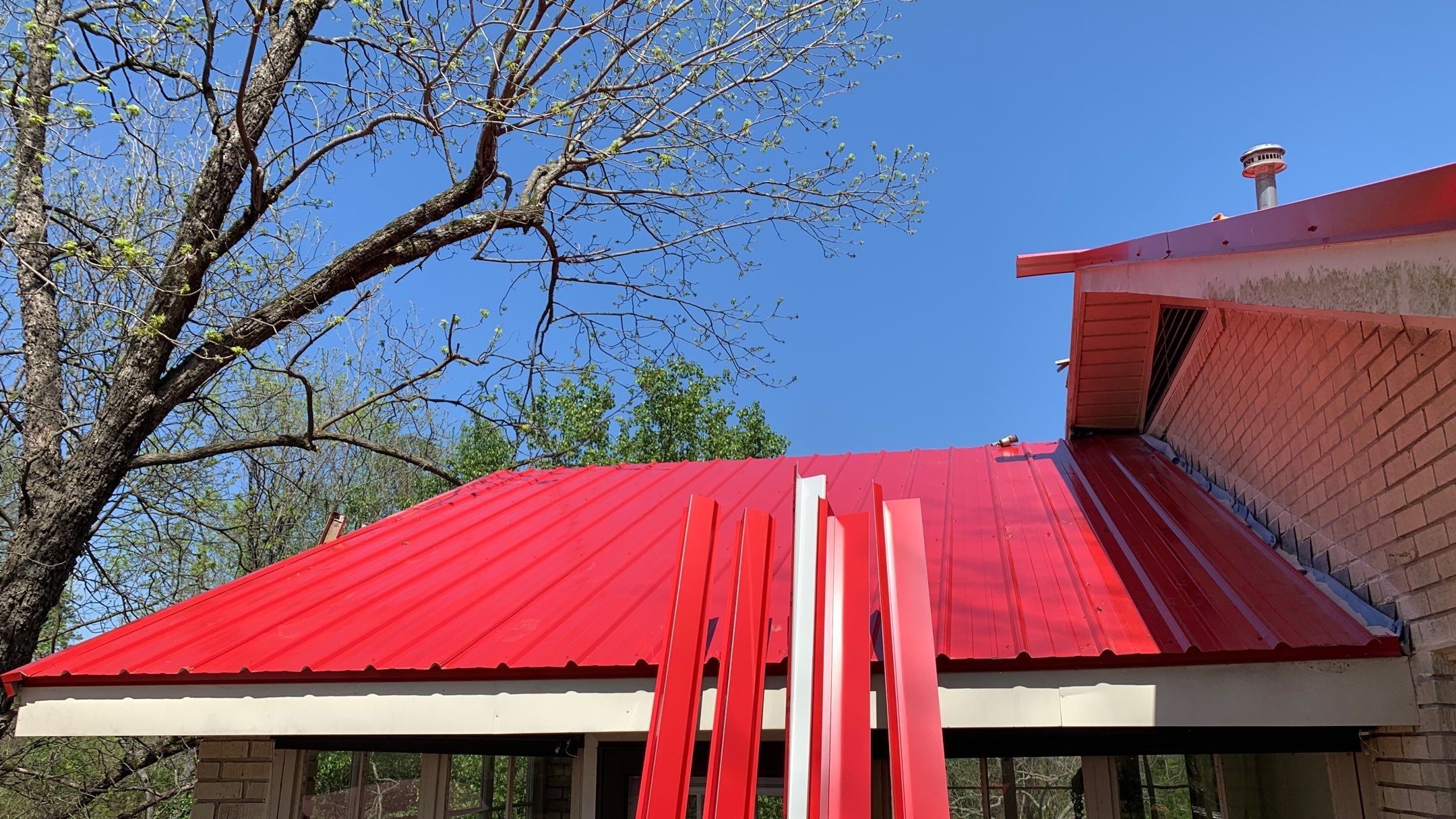 Residential Roofing Installation using 26 Gauge Colored Panels by Hostetler Roofing