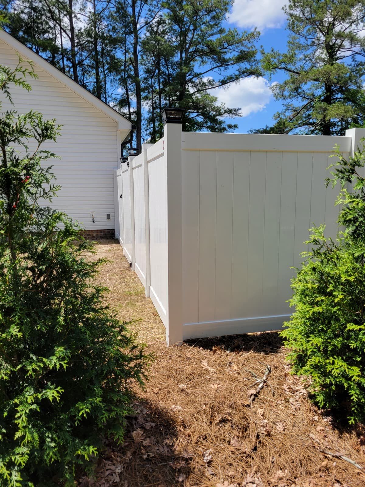 White Vinyl Privacy Fence with Solar Post Caps in Goldsboro by Superior Fence and Rail