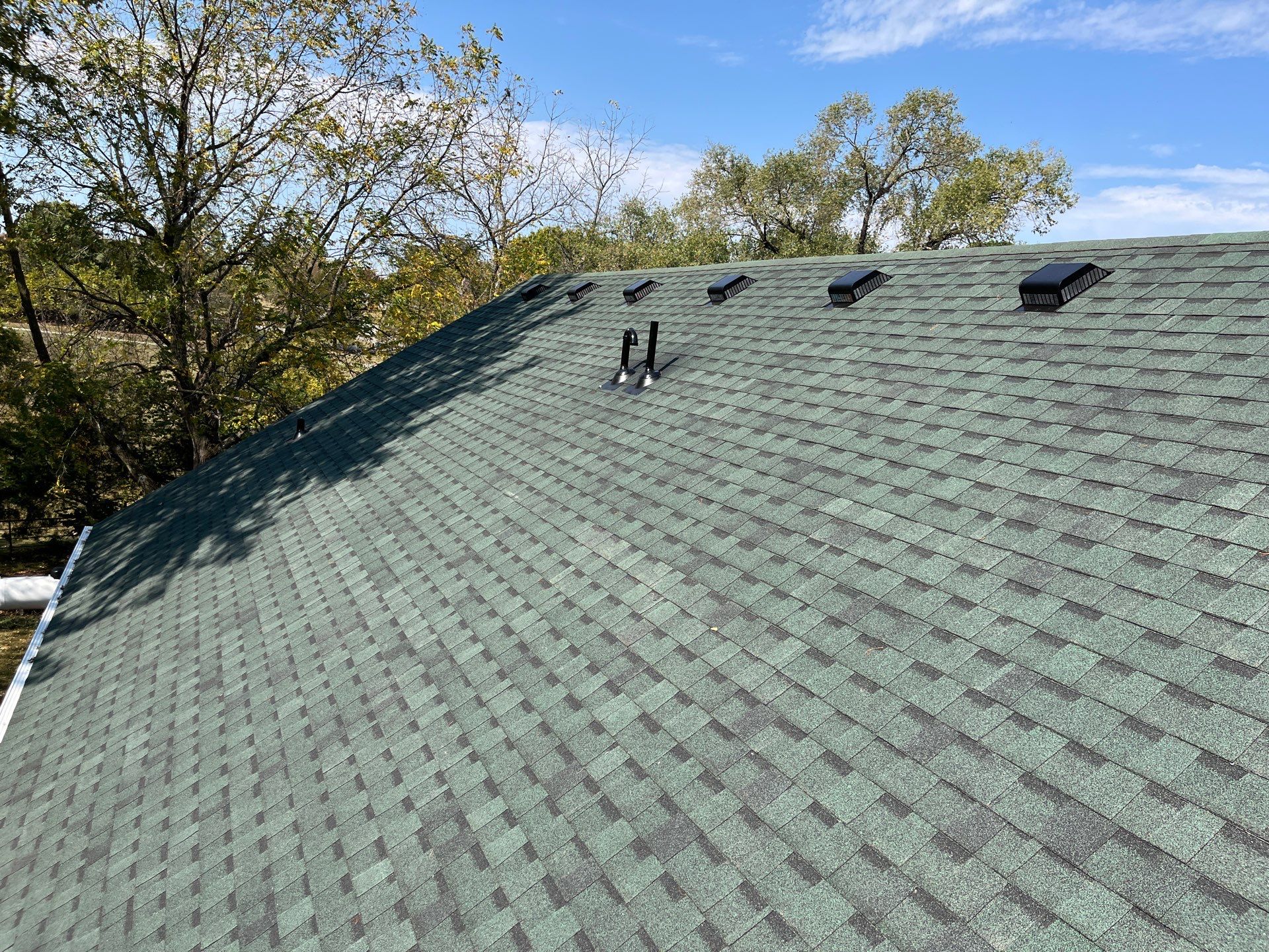 Residential Roofing Install - Green Atlas Pinnacle Pristine Shingles - White Gutters & Downspouts  by Titan Commercial & Residential Roofing 