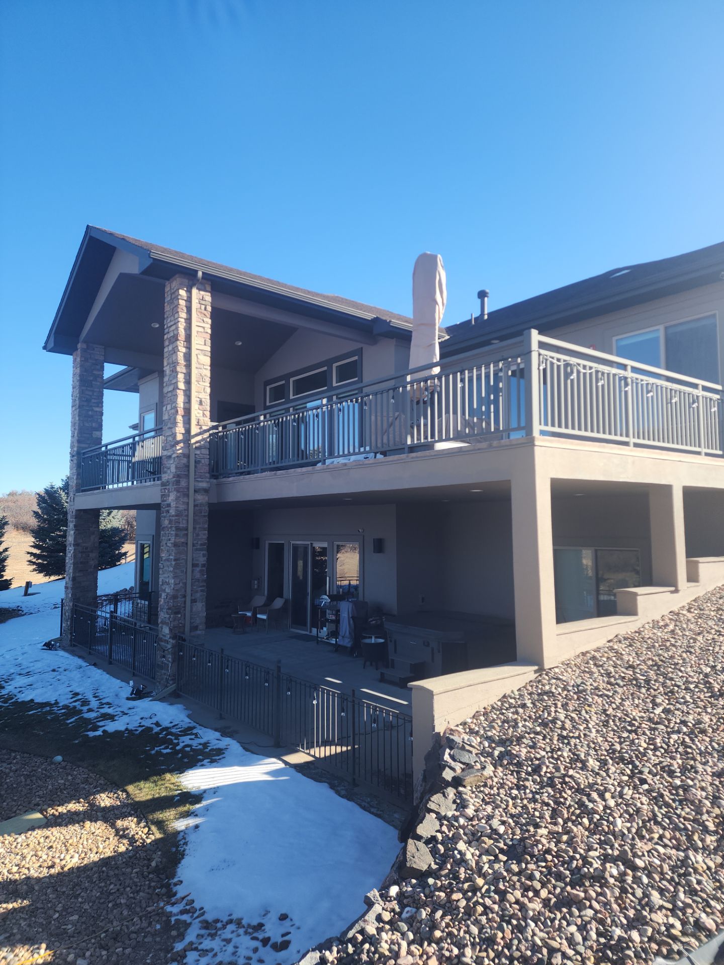 Castle Rock Elegance: White Stucco Exterior with Bold Tricorn Black by J&M Painting LLC
