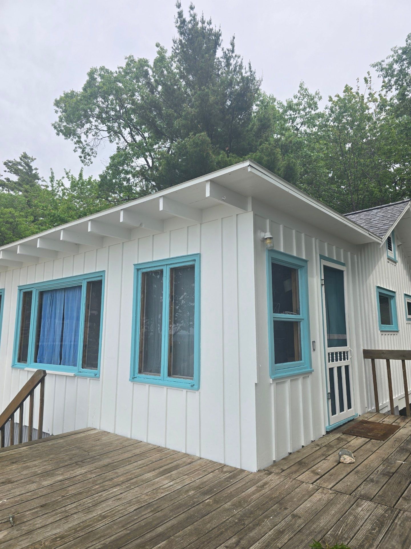 Lakeside Cottage Exterior Painting and Teal Trim Restoration in Mears by Gordon Painting