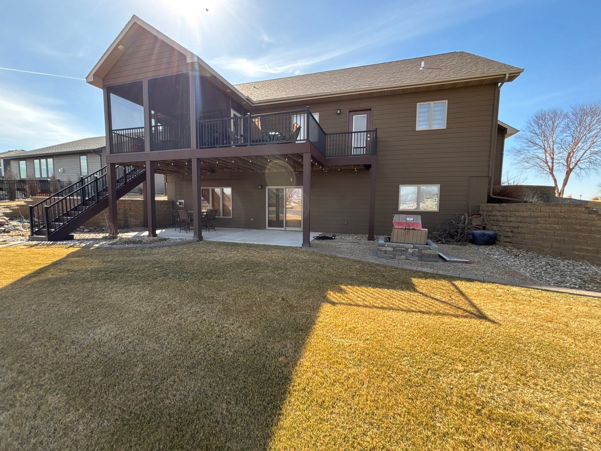 Full Exterior Renovation with Stone Veneer and Composite Decking by Select Painting, Coatings & Garage Cabinets