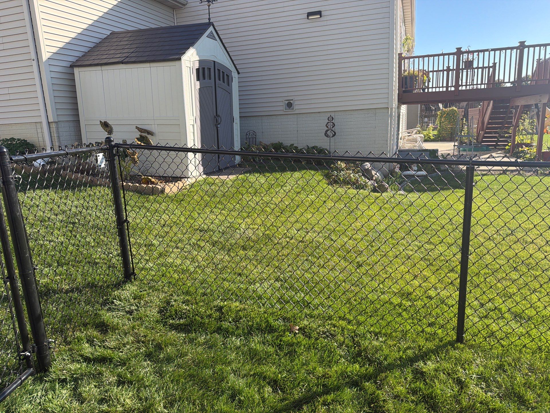 Black Vinyl-Coated Chain Link Fence Installation in Cedar Falls by Perfect Picket Fence and Stain