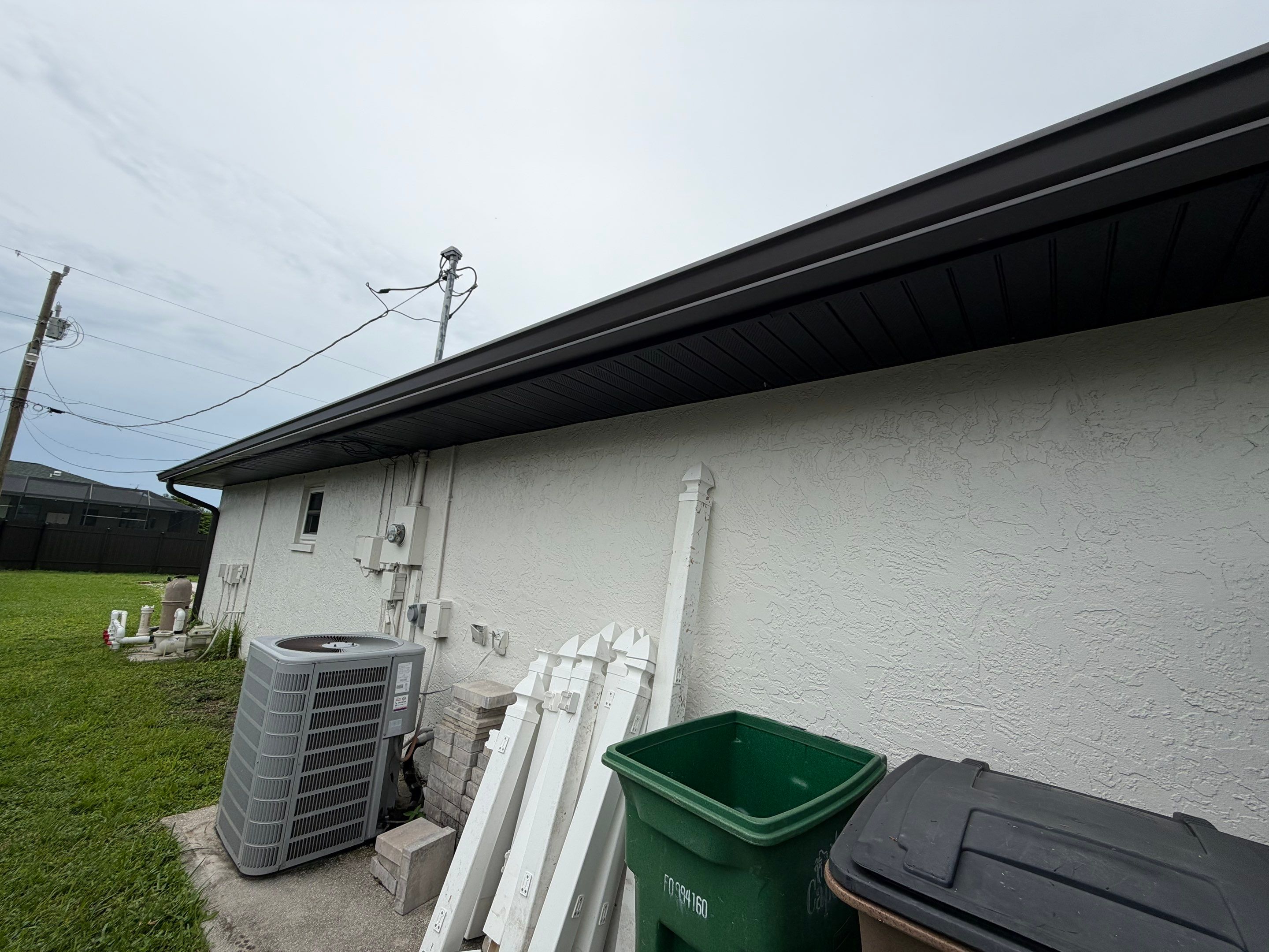 Black Seamless Gutters for a Modern Look in Cape Coral FL by Gutter Professors