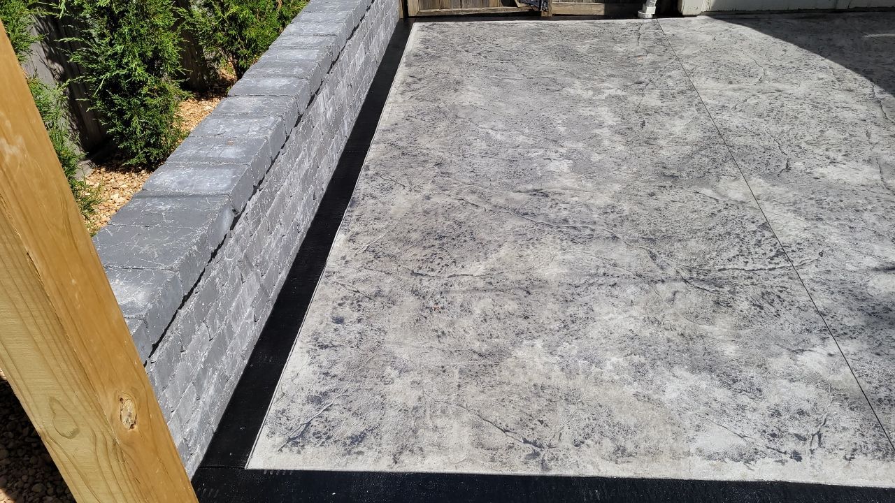 Back Yard Stamped Concrete Patio by LAND ESCAPES LLC