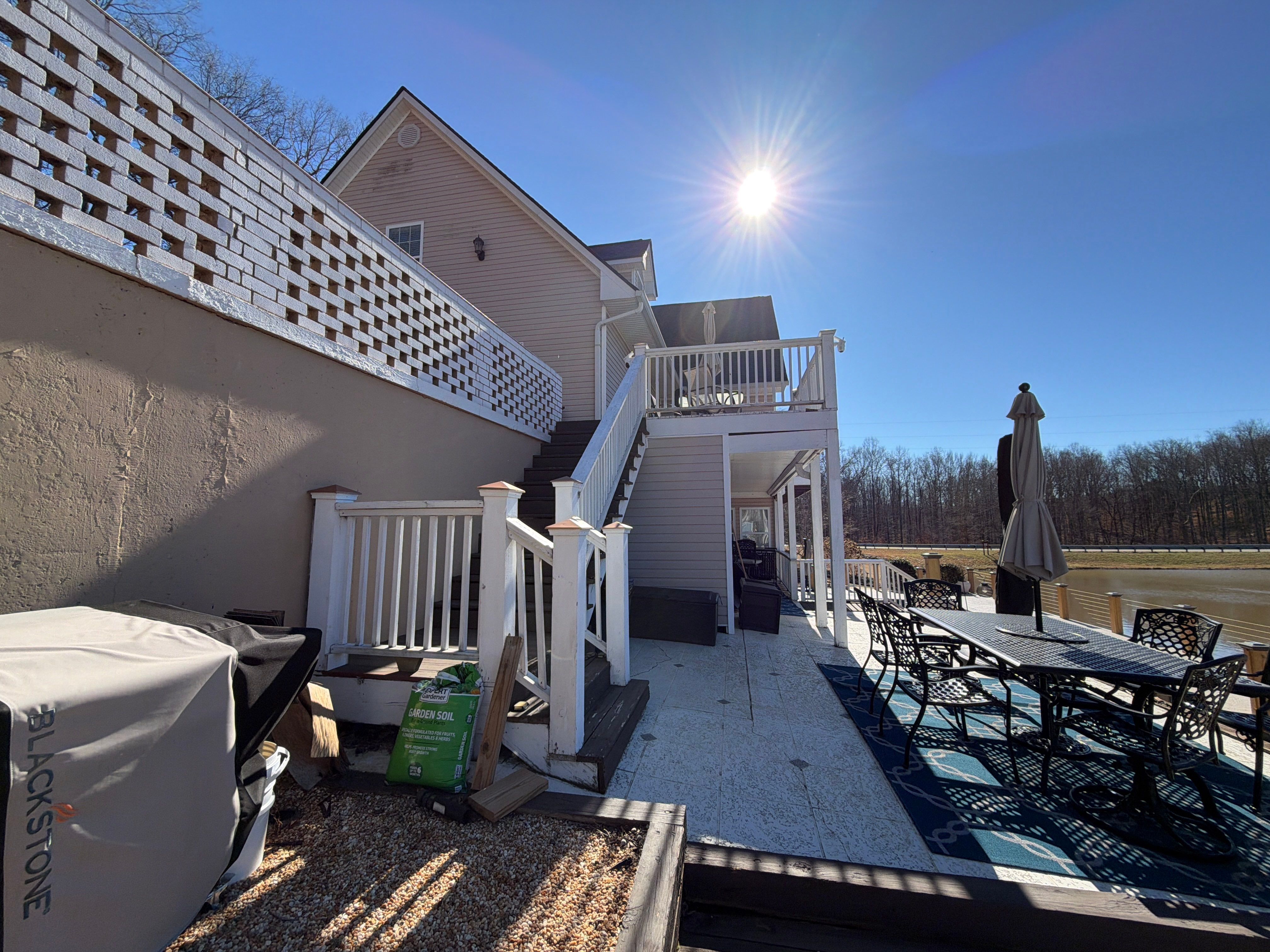 Cumming, GA Lake House Deck Resurface and Extension using Pressure Treated Pine and Skyline Cable Railing by Nelson Exteriors 