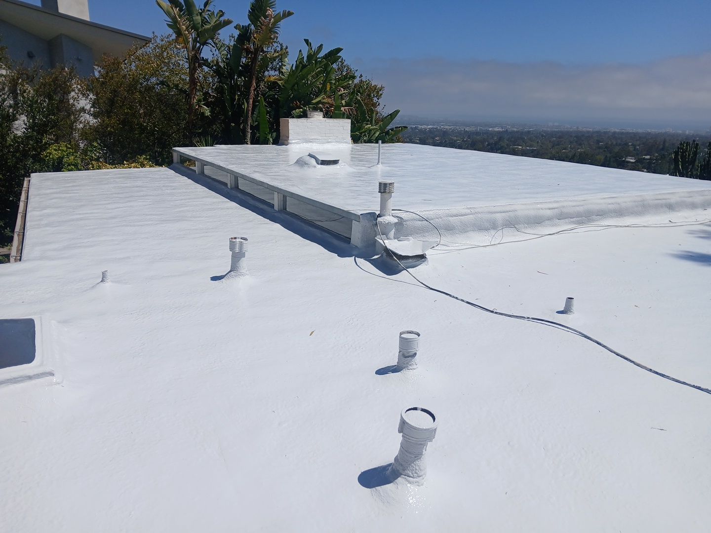 Residential Flat Roof Restoration with Silicone Coating in Brentwood by Hull Brothers Roofing