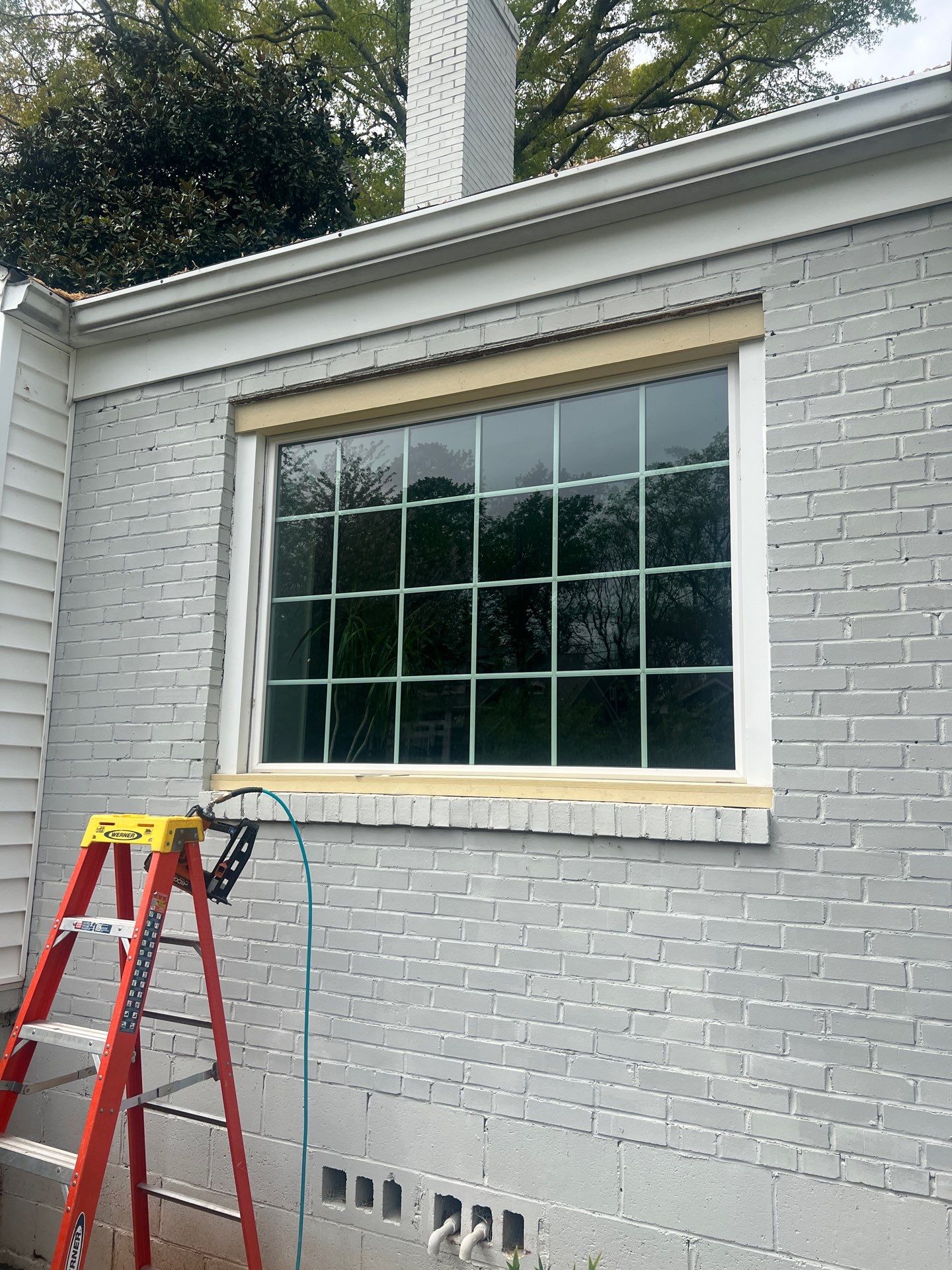 Decatur Exterior Renovation Featuring Painted Brick and Custom Blue Door by Swift Home Renovations