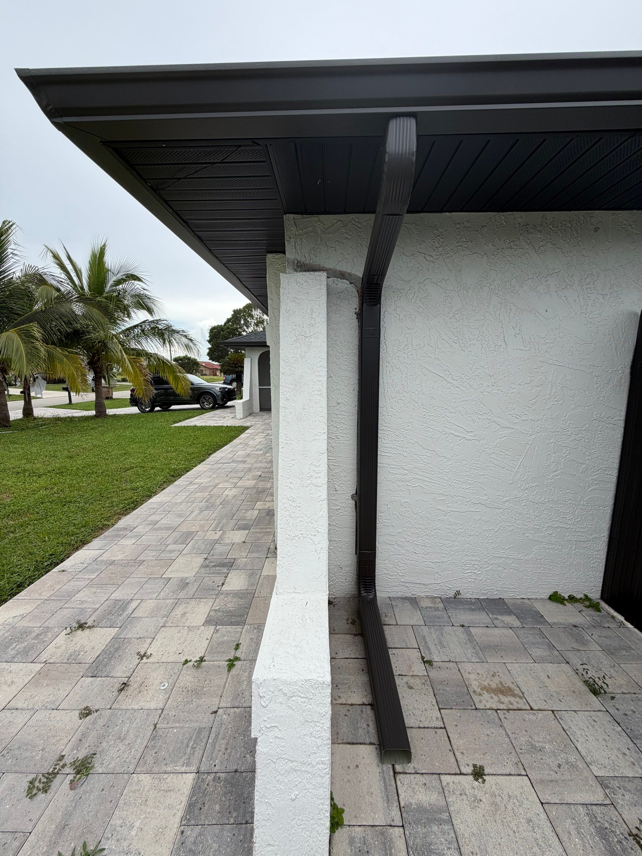Black Seamless Gutters for a Modern Look in Cape Coral FL by Gutter Professors