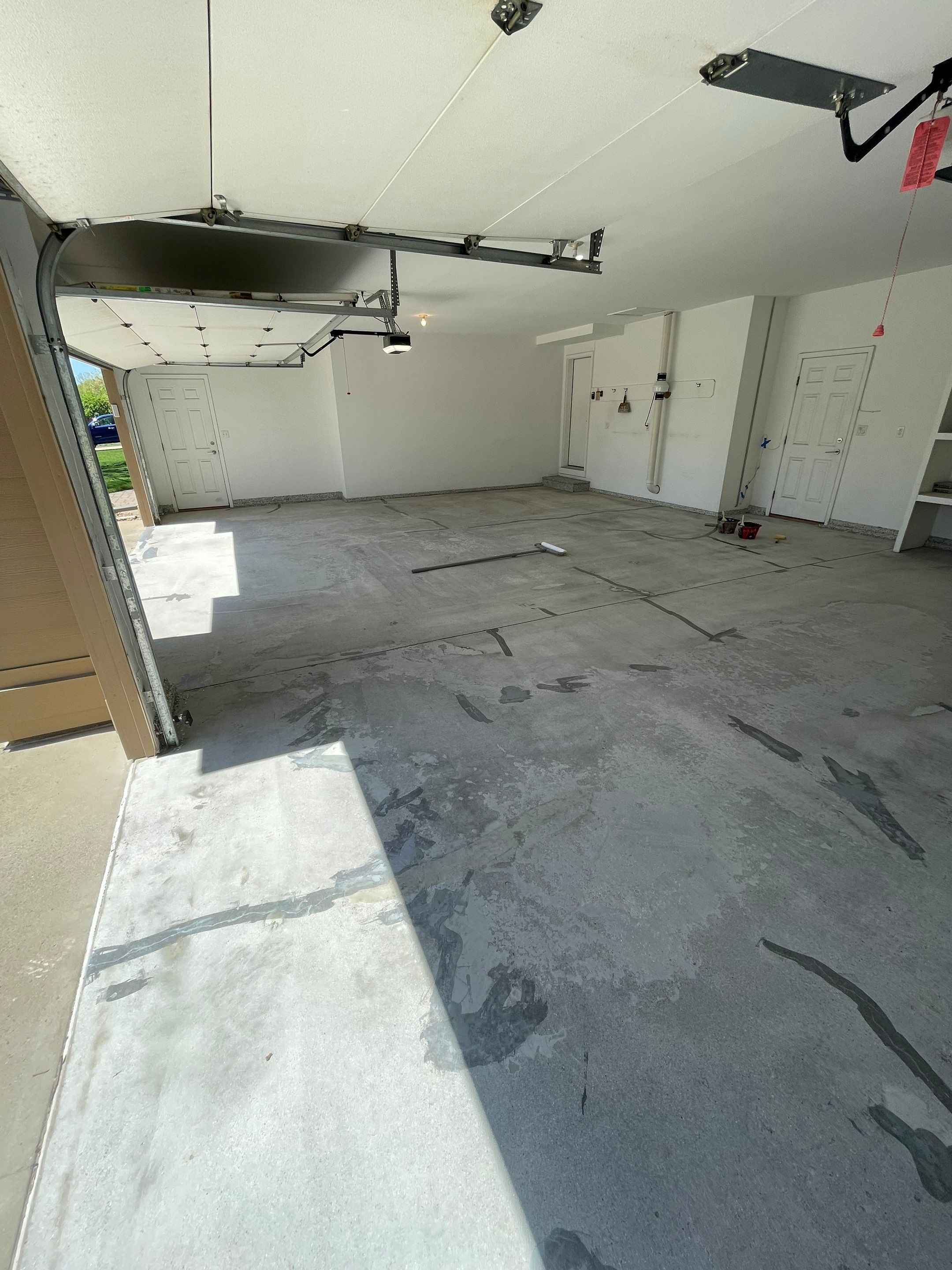 Yankton Garage Floor Restoration with Gray Speckled Epoxy Coating by Select Painting, Coatings & Garage Cabinets