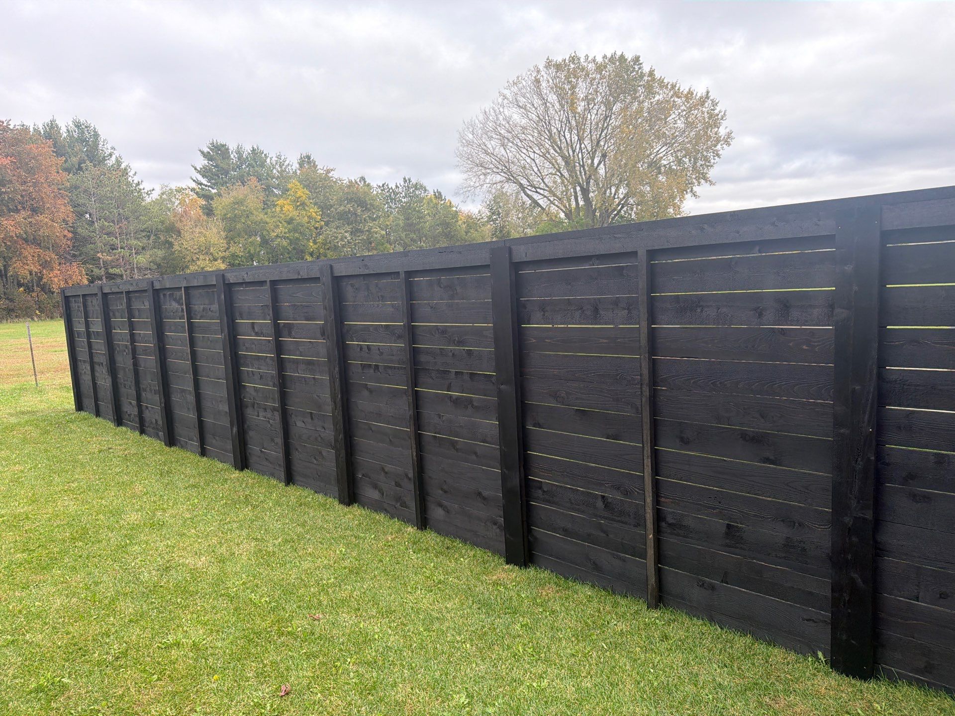 Modern Horizontal Wood Privacy Fence Installation in Cedar Falls by Perfect Picket Fence and Stain