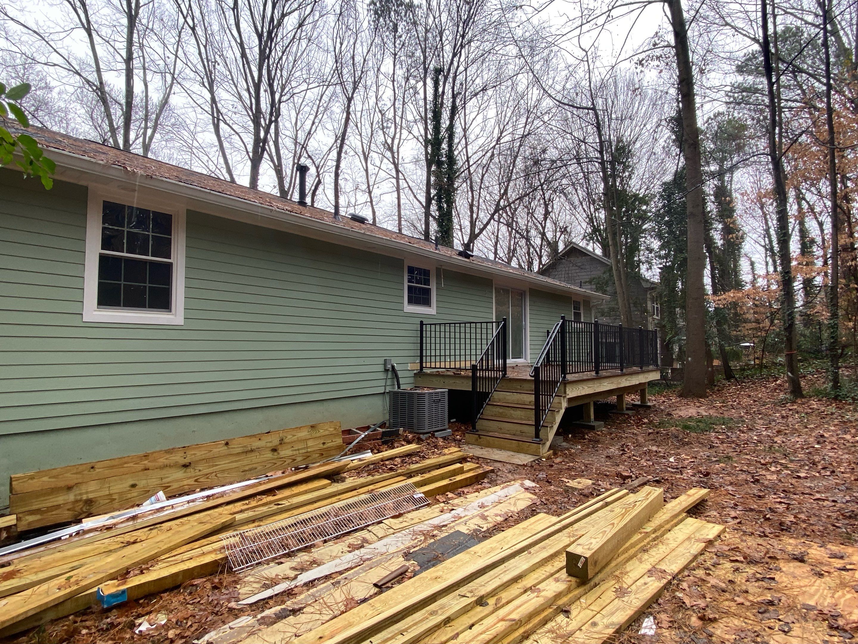 Elevated Wood Deck Construction With Black Metal Railings In Atlanta by Swift Home Renovations