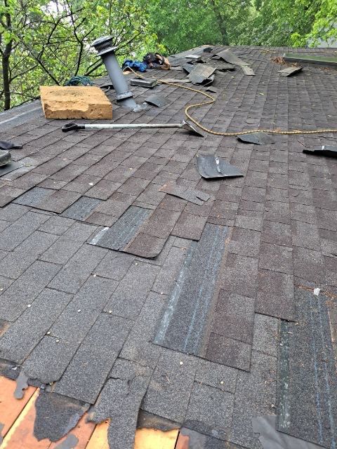 roof replacement and new black gutters by Nailed It Roofing & Remodeling LLC